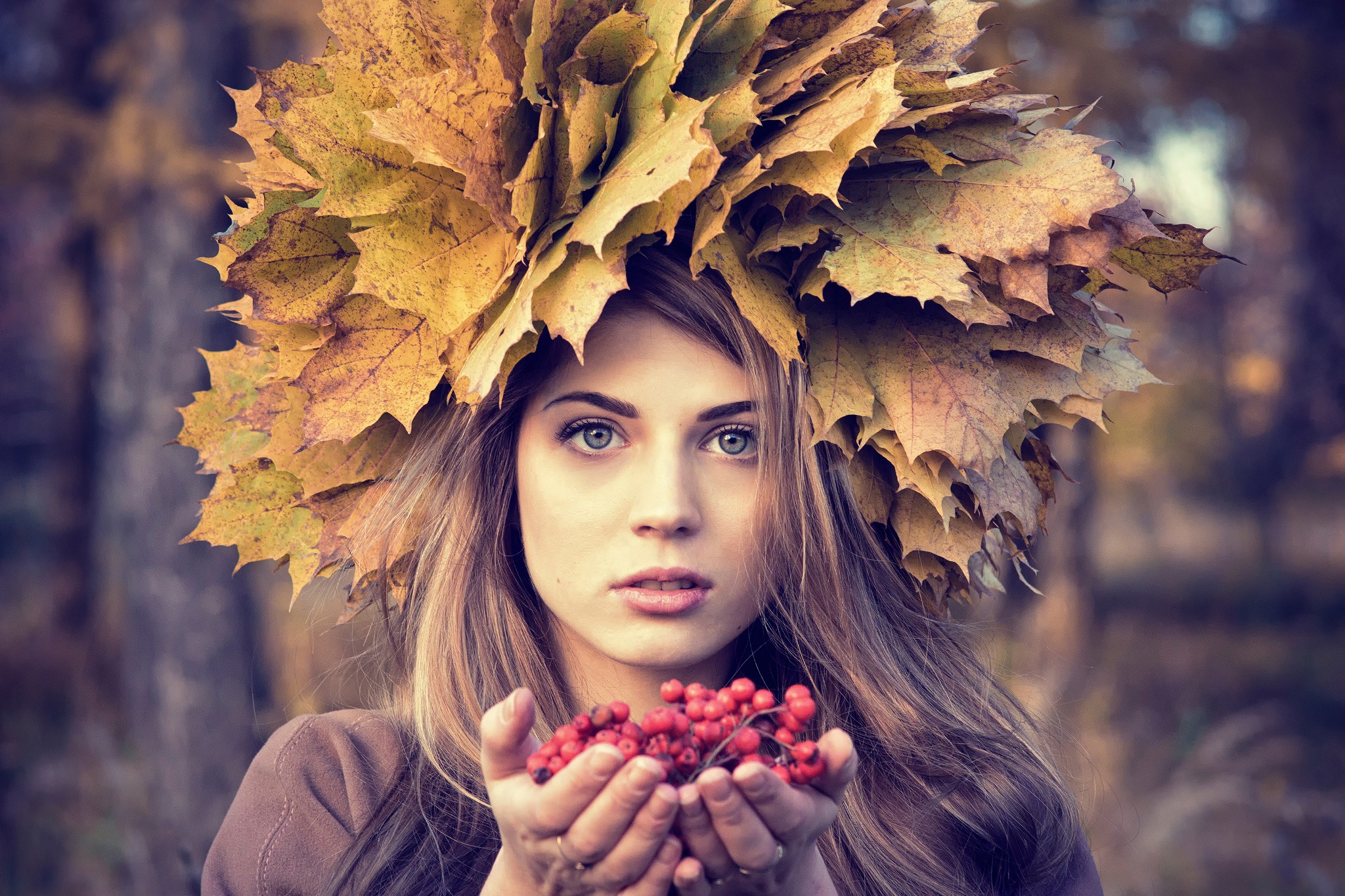 Woman wearing a crown of autumn leaves holding berries HD Wallpaper