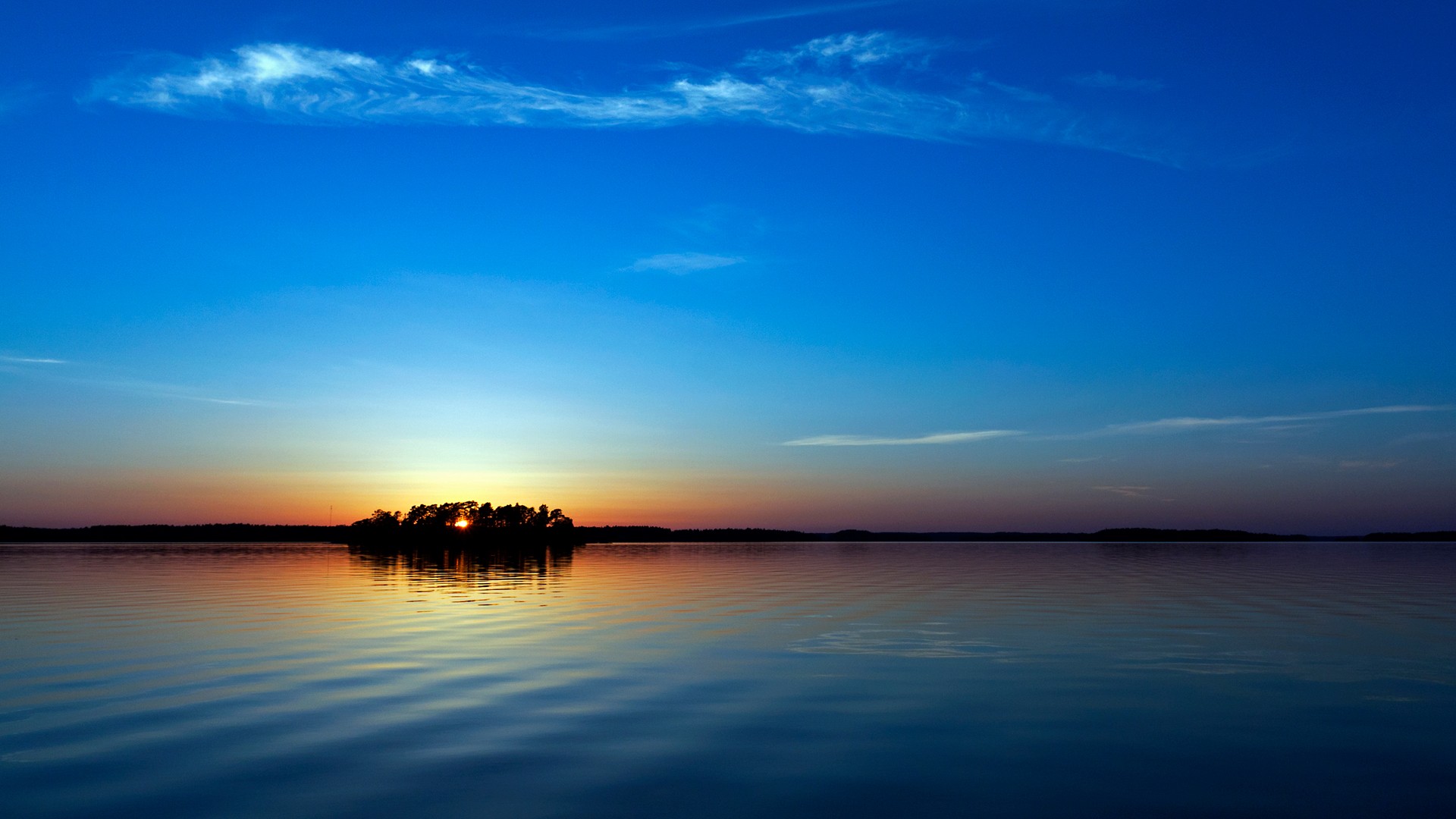 Sunset over a calm lake with an island HD Wallpaper