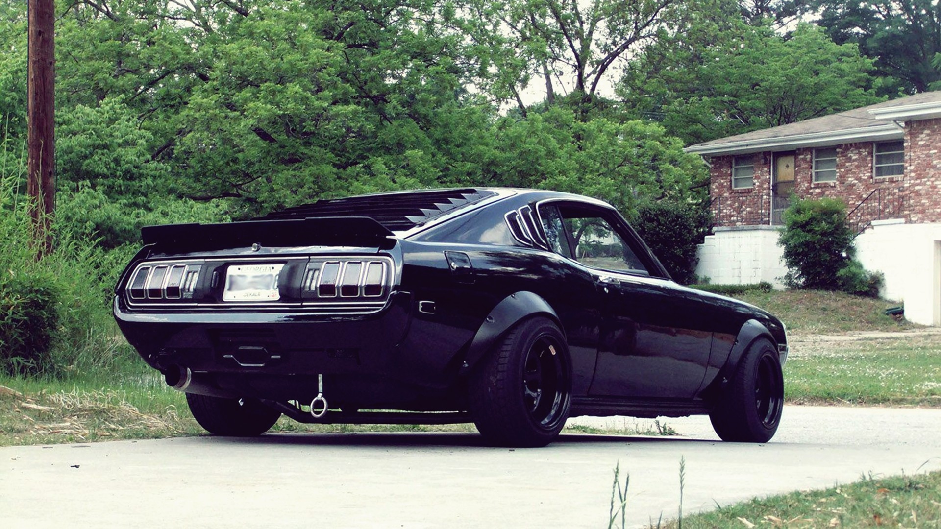 Black Toyota Celica with widebody kit on a street HD Wallpaper