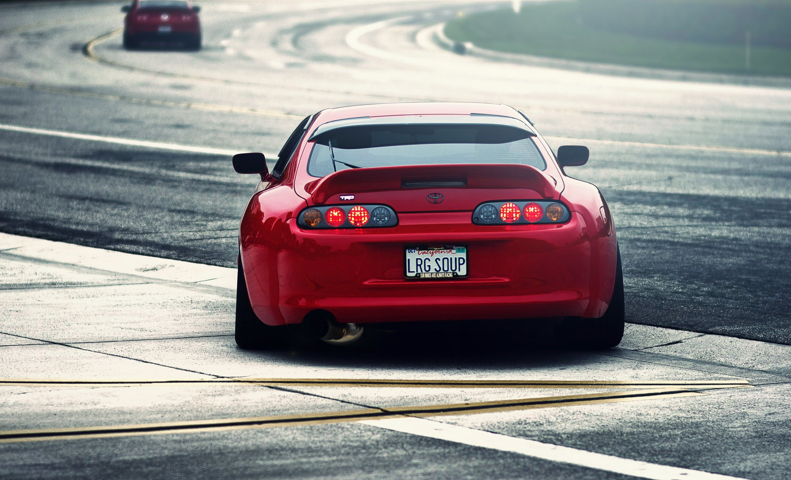 Red Toyota Supra TRD on a race track HD Wallpaper