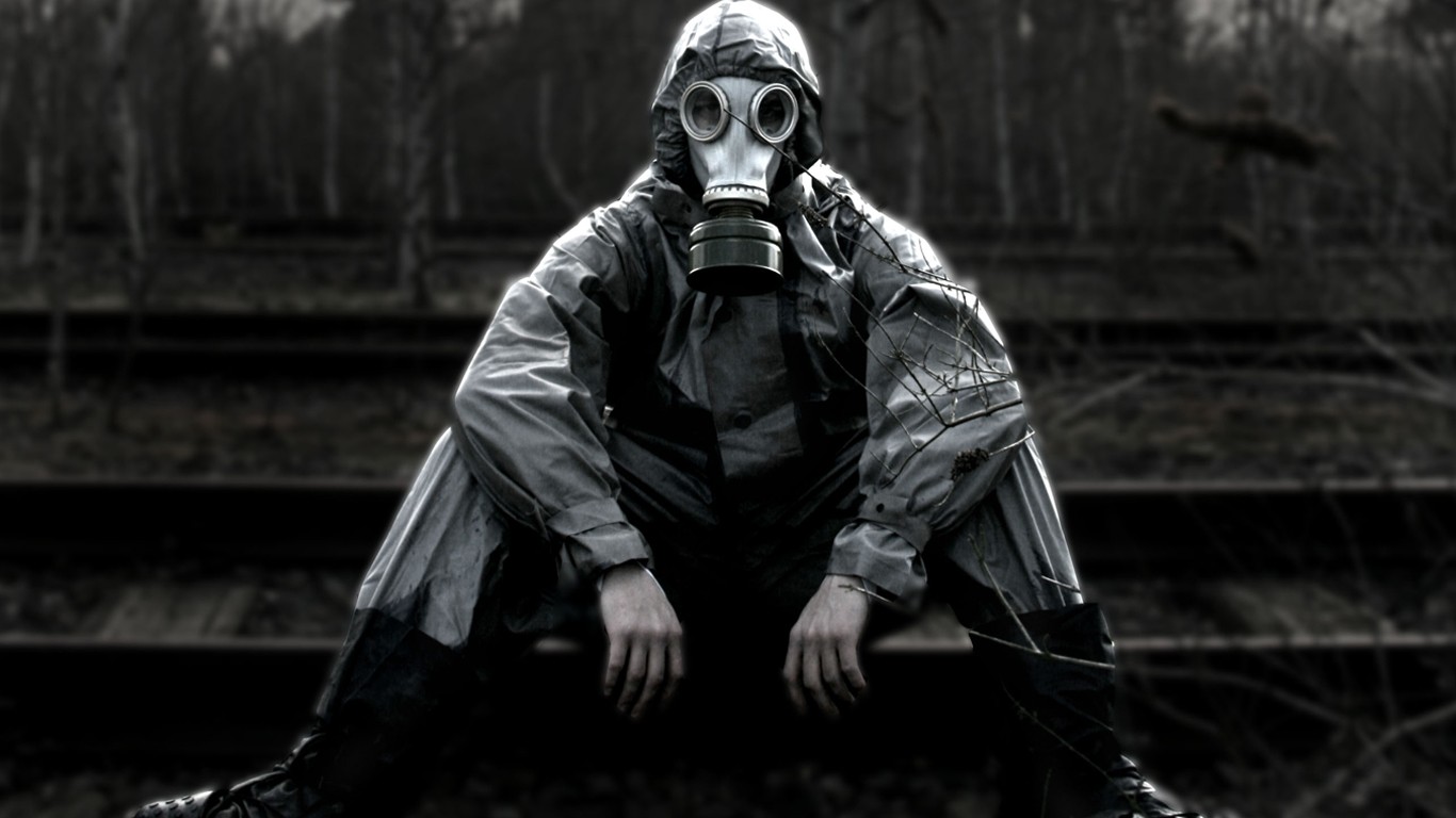 Person in gas mask on railway tracks HD Wallpaper