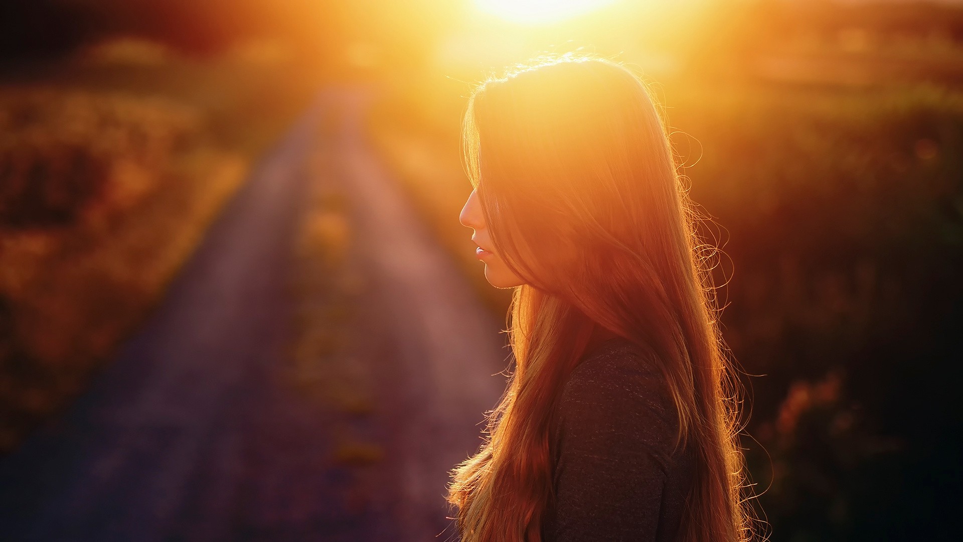 Woman with long hair in profile at sunset HD Wallpaper