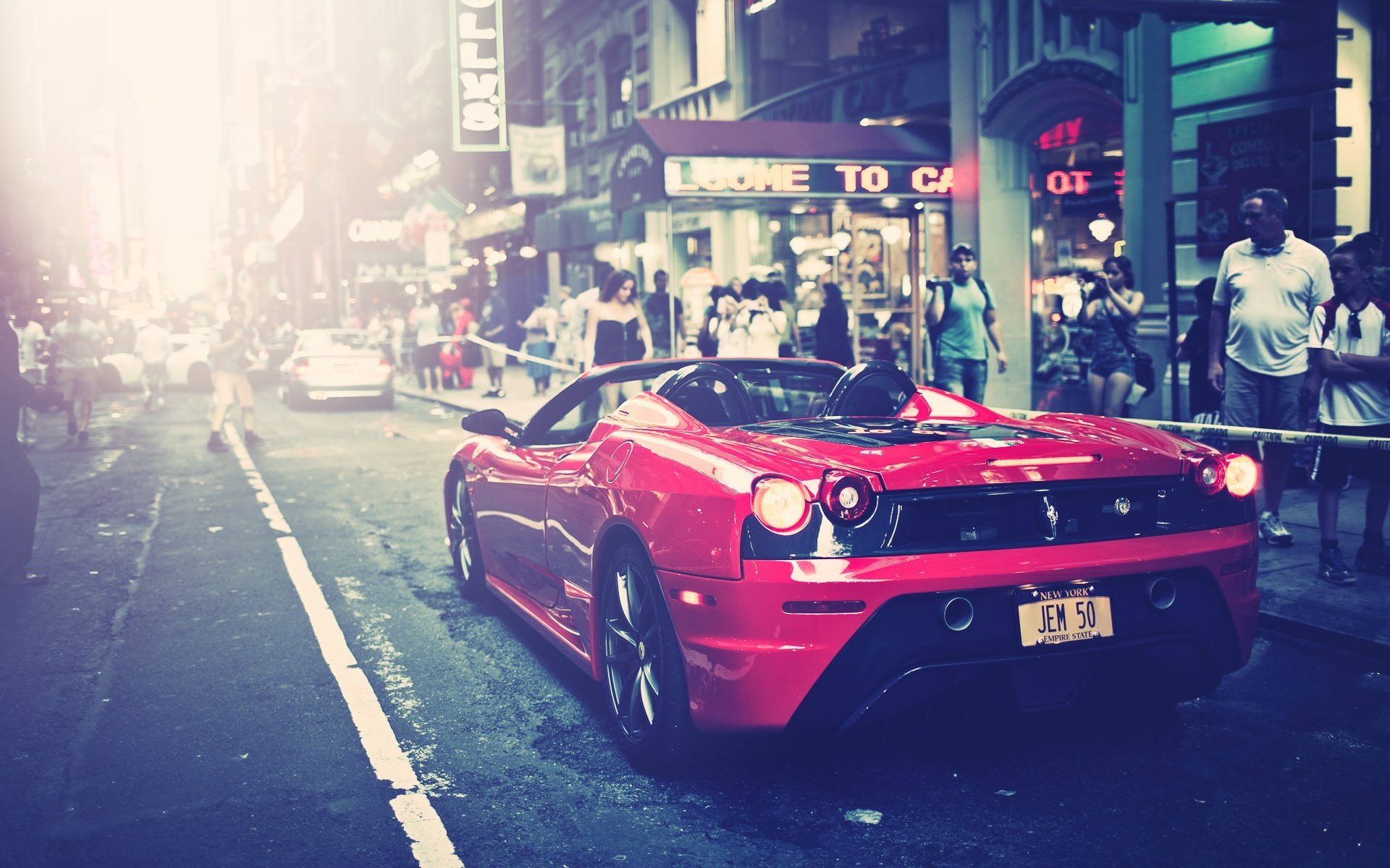 Red Ferrari sports car on a city street HD Wallpaper
