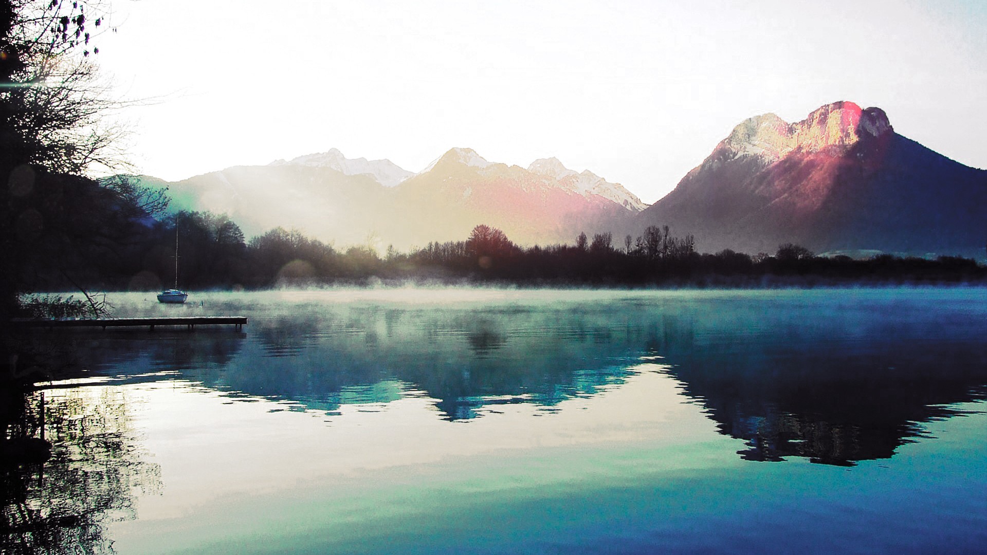 Boat on a misty lake with mountains reflection HD Wallpaper