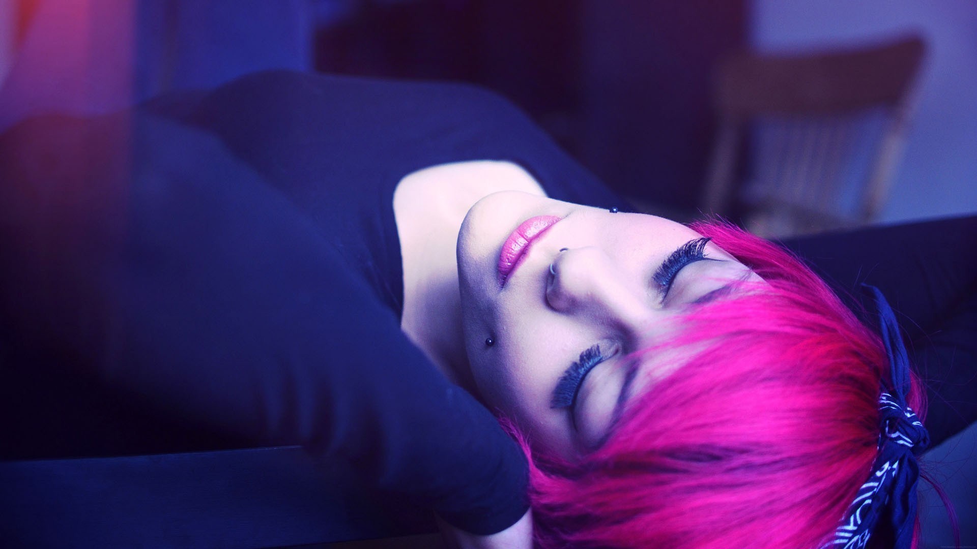Woman with pink hair and piercings lying down HD Wallpaper