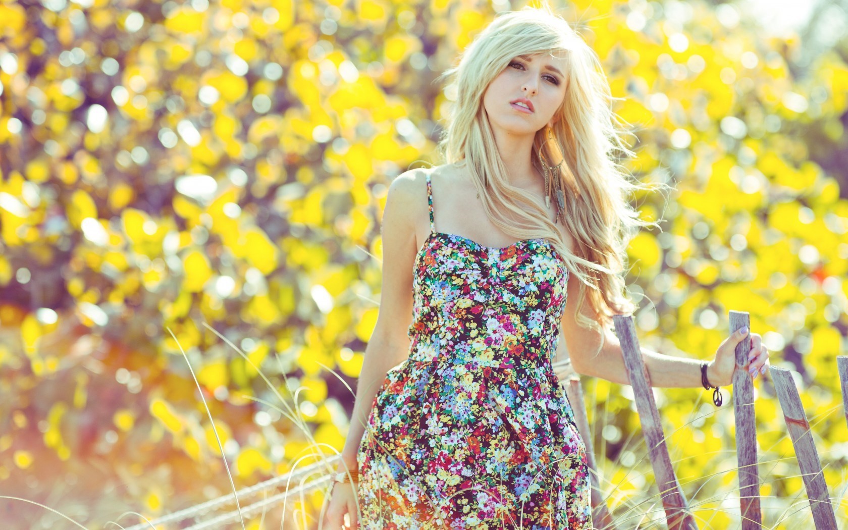 Woman with blonde hair in a floral dress outdoors HD Wallpaper