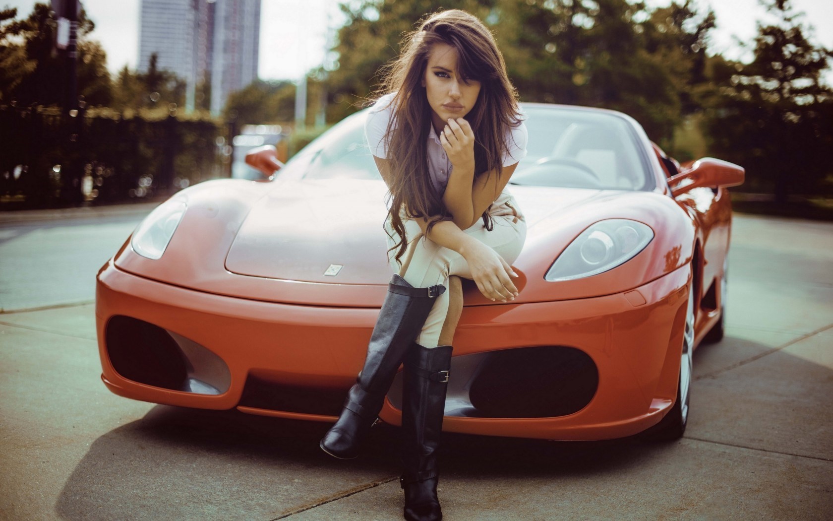 Woman sitting on a red Ferrari sports car HD Wallpaper