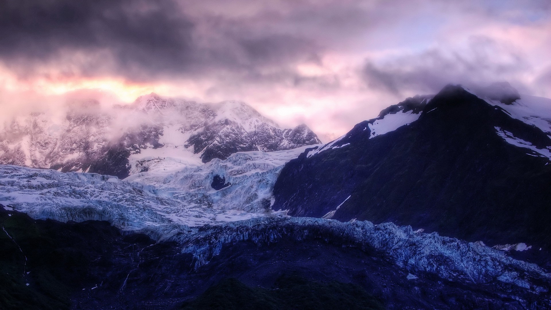 Glacier and snow-capped mountains under dramatic clouds HD Wallpaper