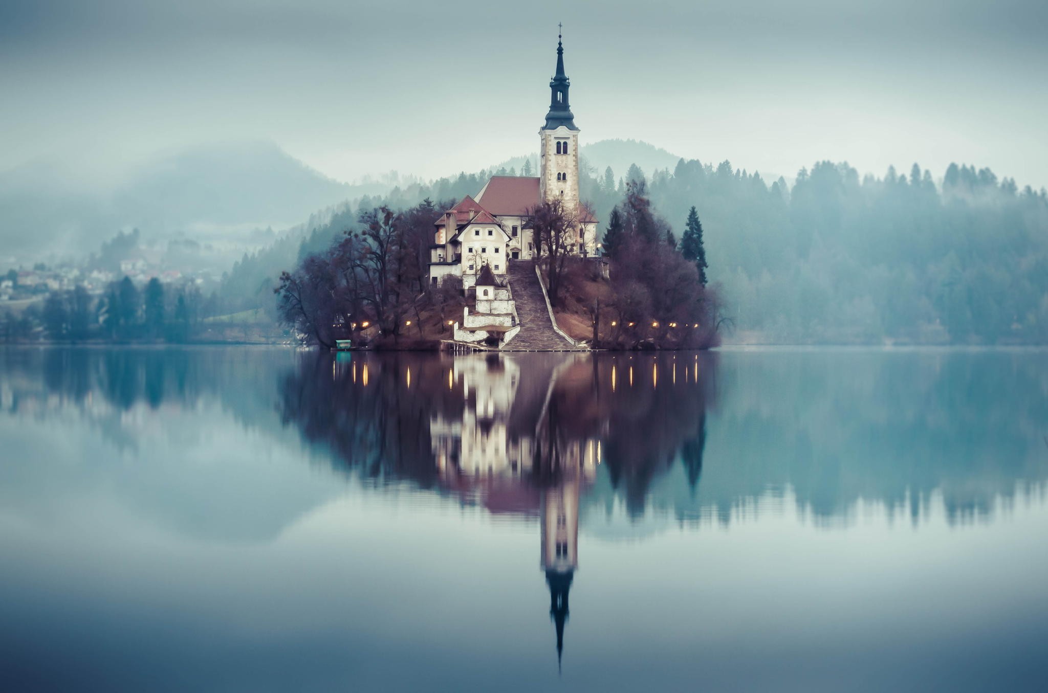 Church on an island in a misty lake with reflection HD Wallpaper