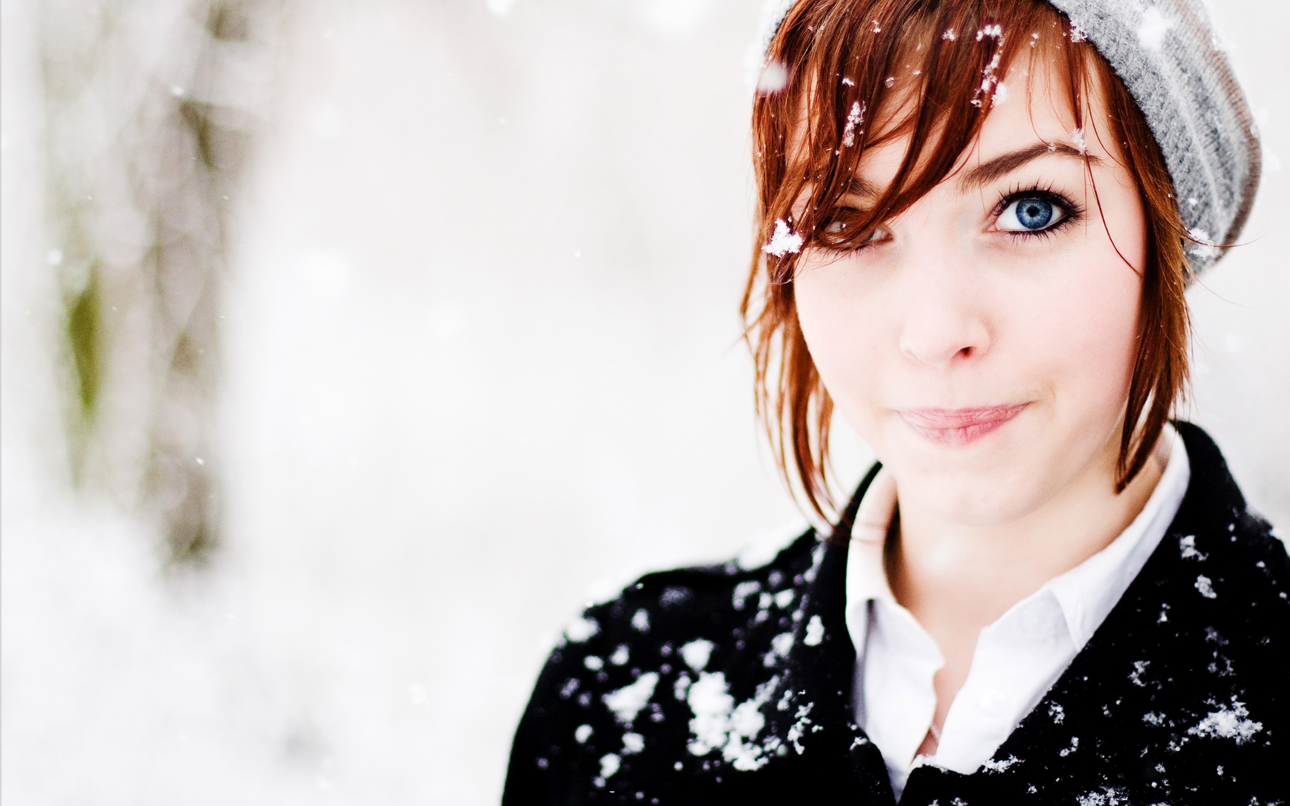 Redhead woman with blue eyes in the snow HD Wallpaper