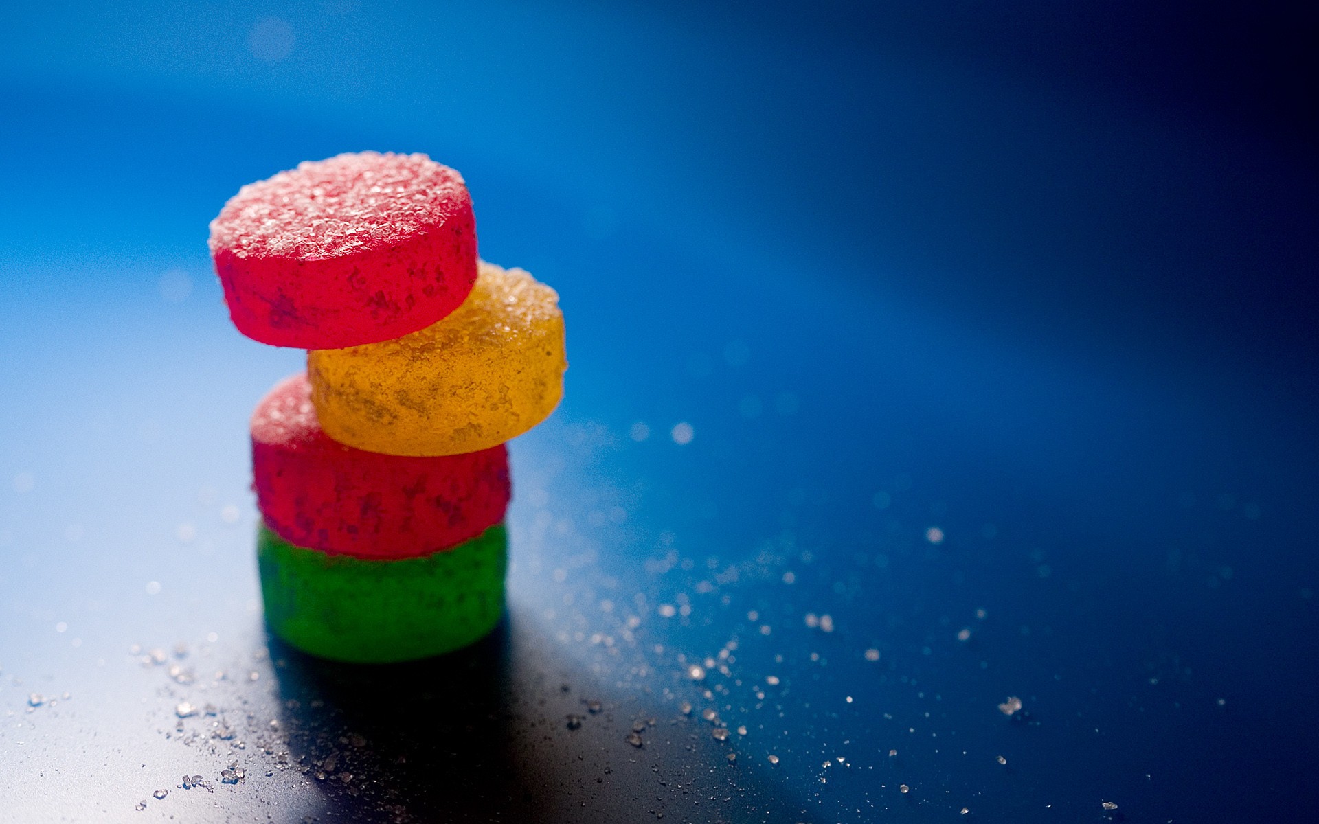 Stack of colorful gummy candies covered in sugar HD Wallpaper