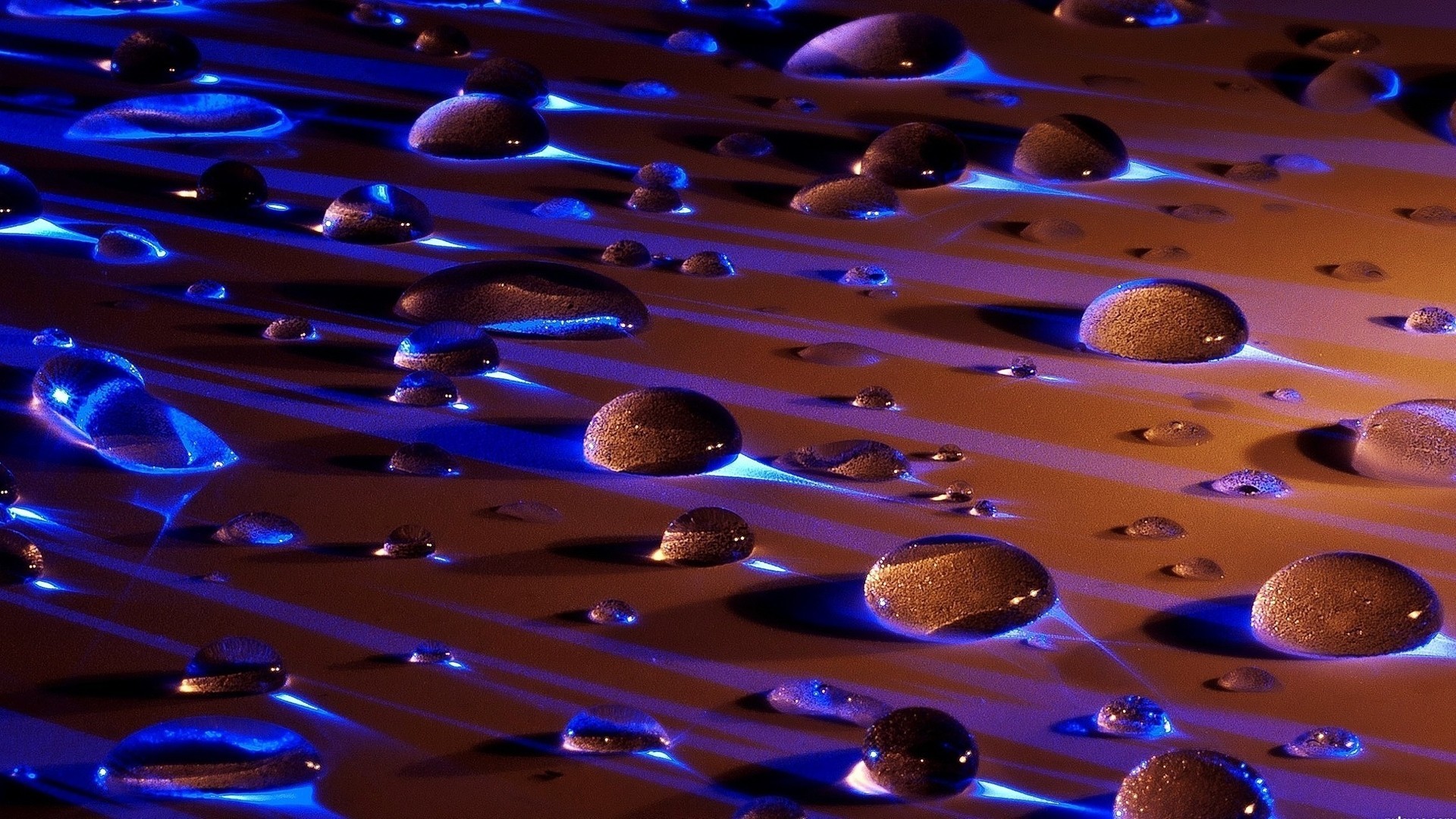 Macro view of water drops with blue and orange light HD Wallpaper