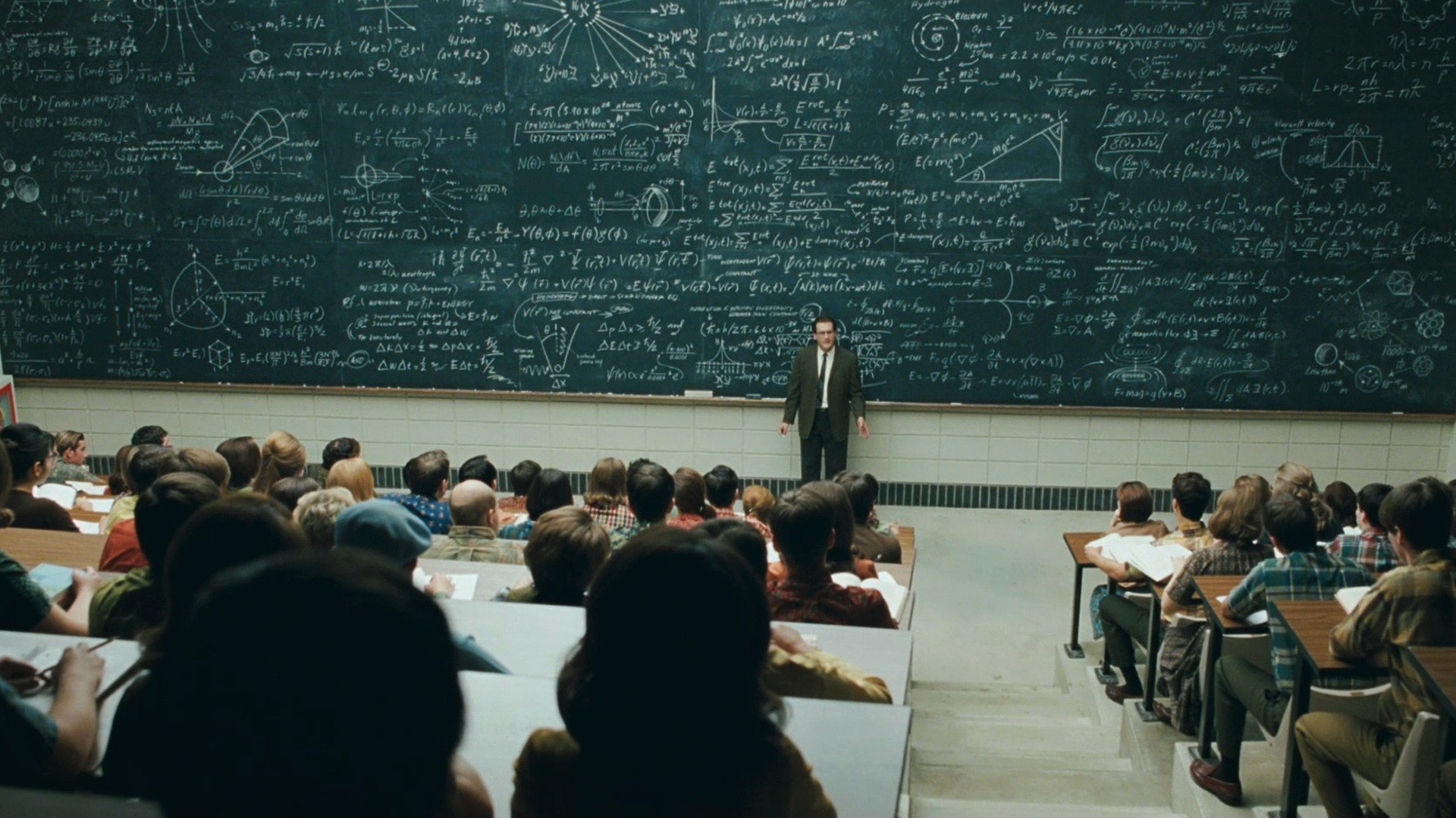 Professor teaching math to students in a classroom HD Wallpaper