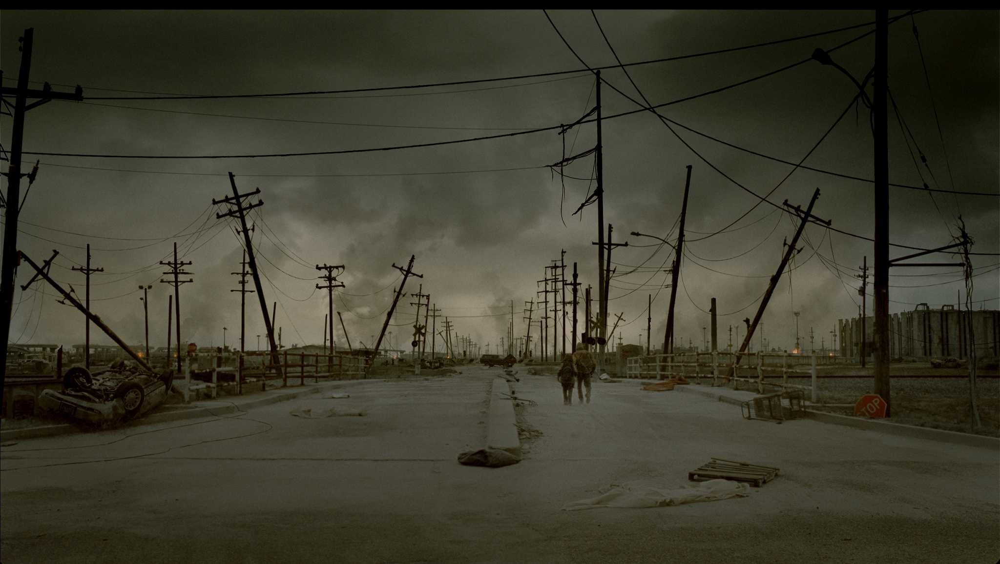 The Road (Movie) apocalyptic wasteland with people and overturned car HD Wallpaper