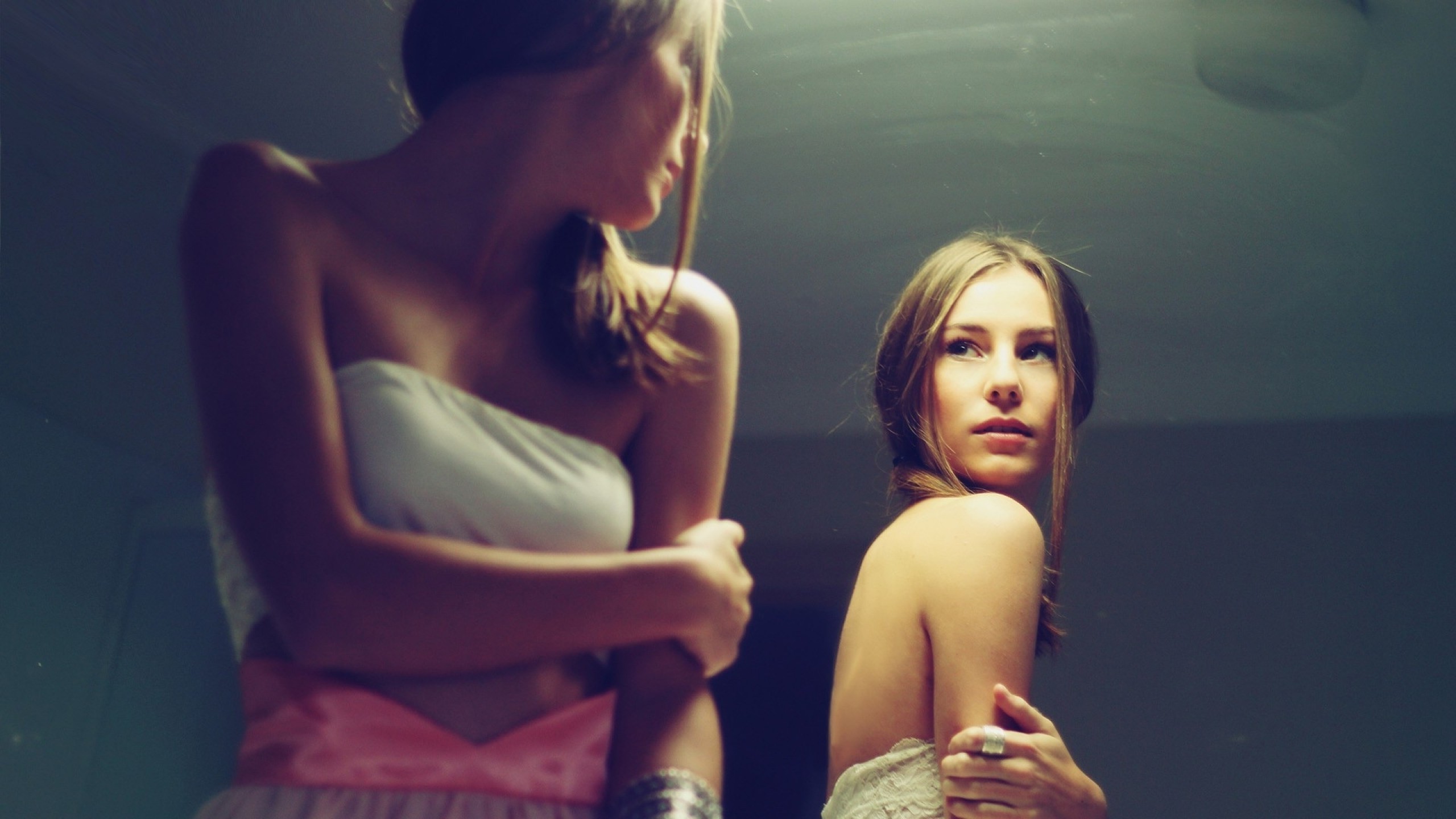 Woman looking at her reflection in a mirror HD Wallpaper