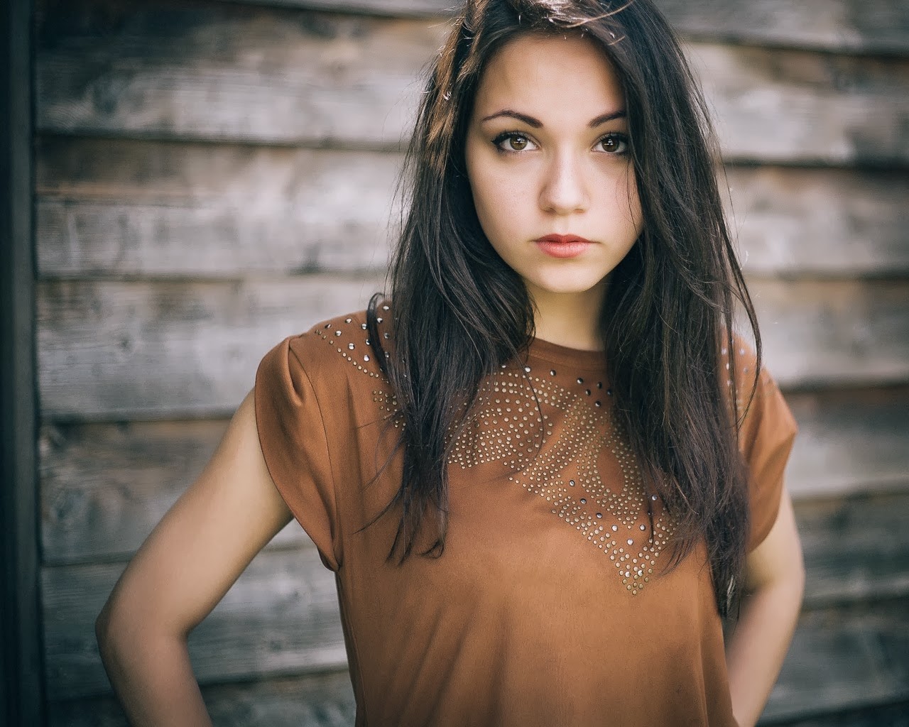 Brunette woman with dark hair and brown shirt HD Wallpaper