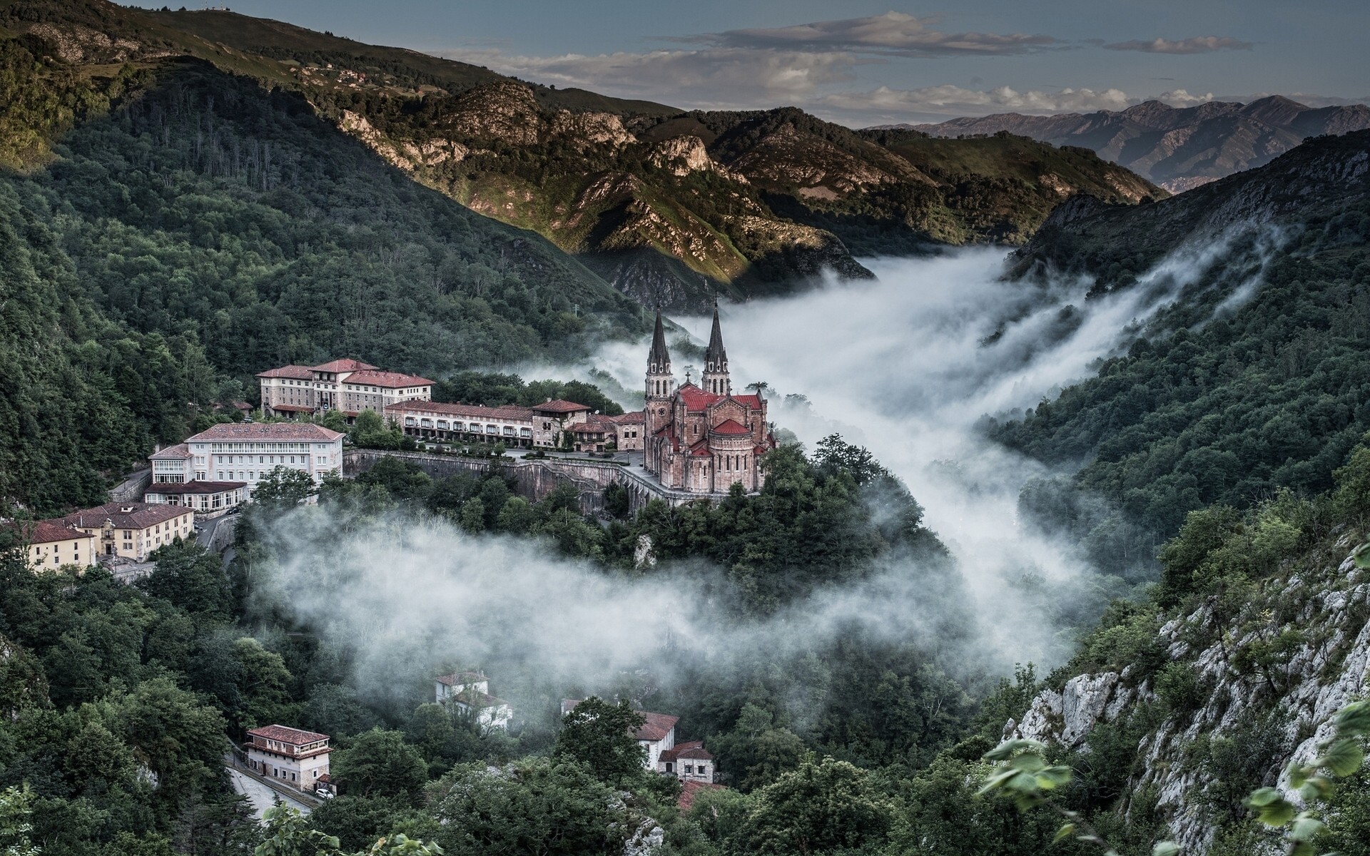 Covadonga Basilica surrounded by mist in a mountain landscape HD Wallpaper