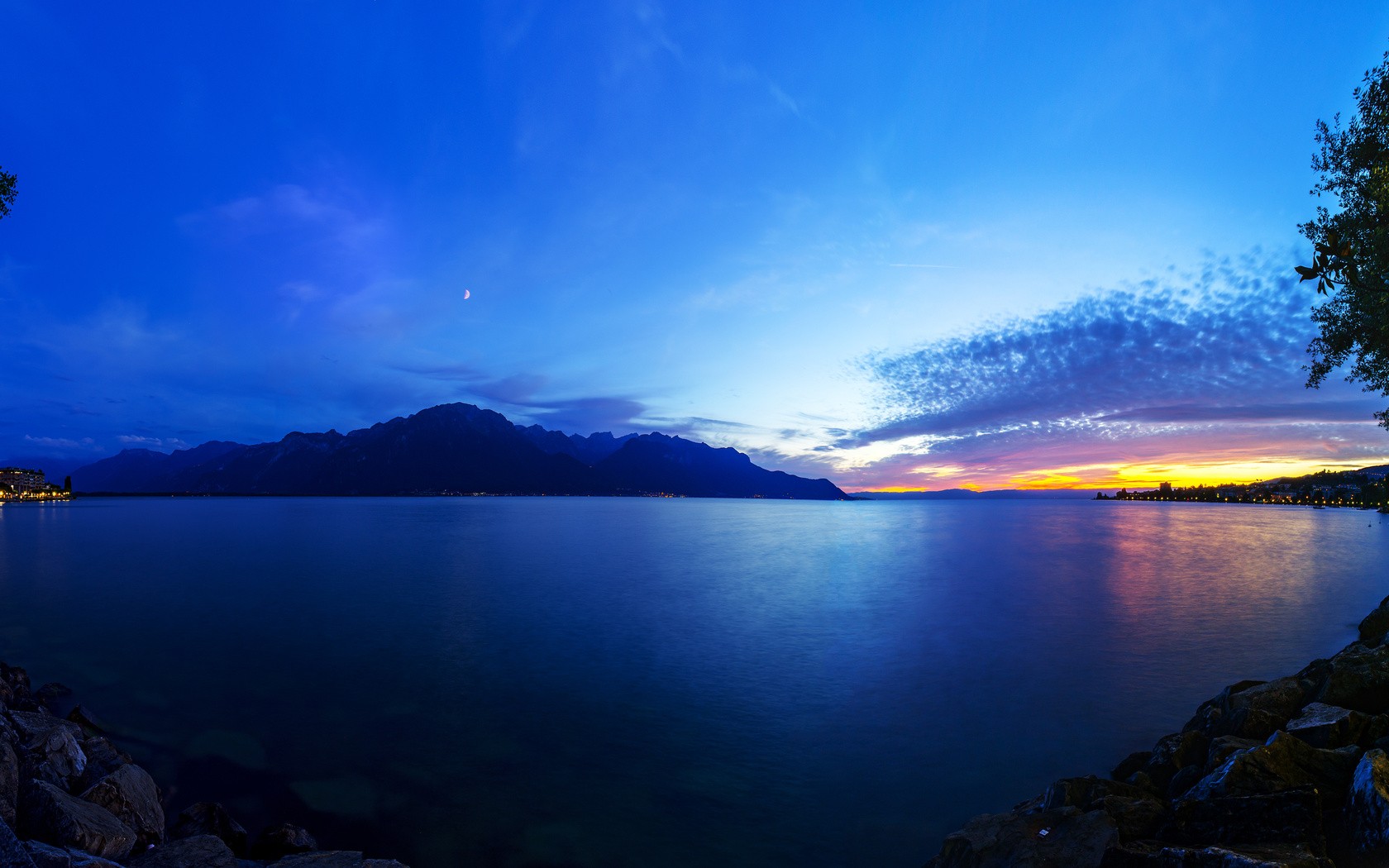 Mountains and lake at sunset with crescent moon HD Wallpaper