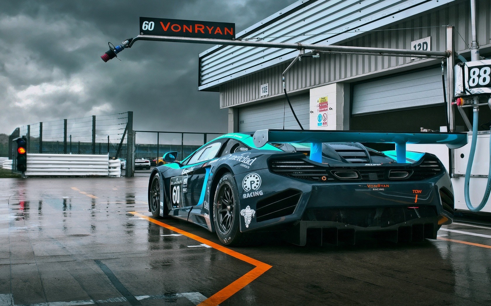 McLaren P1 GTR racing car on a wet track HD Wallpaper