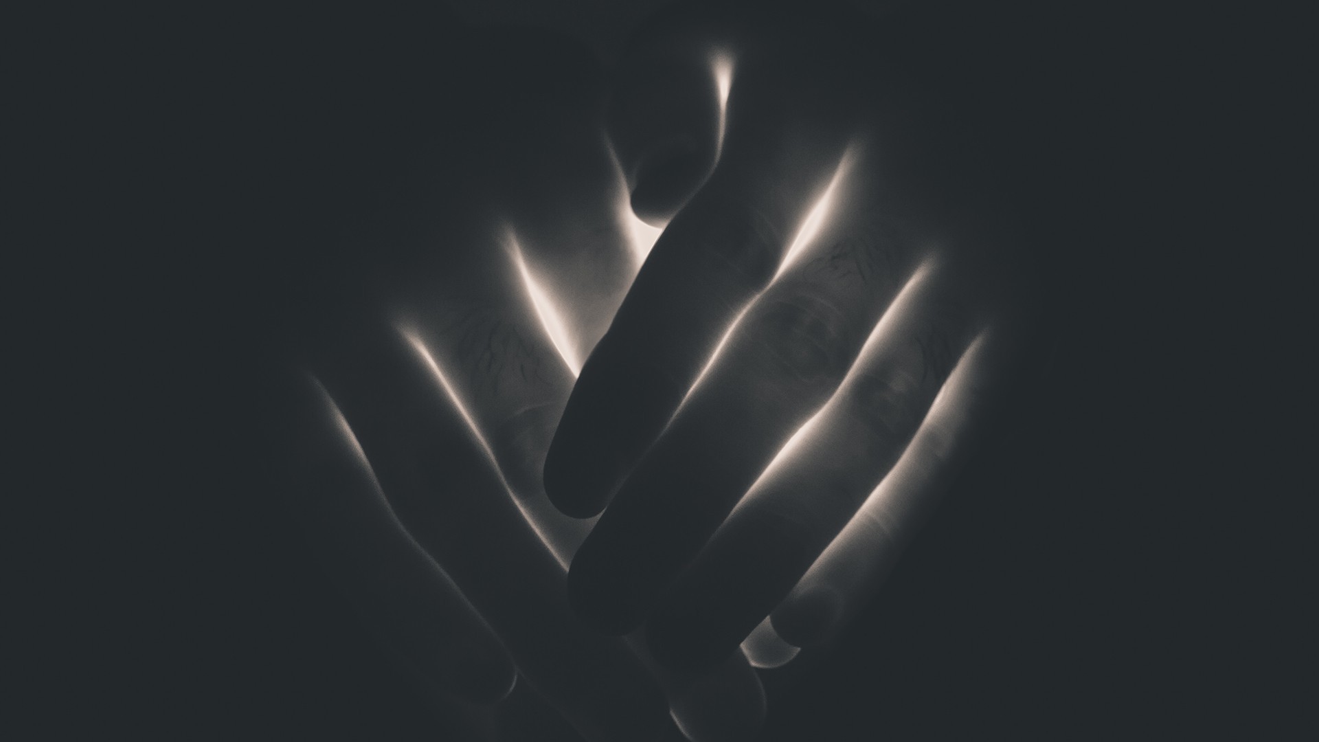 Close-up of hands with dramatic lighting HD Wallpaper