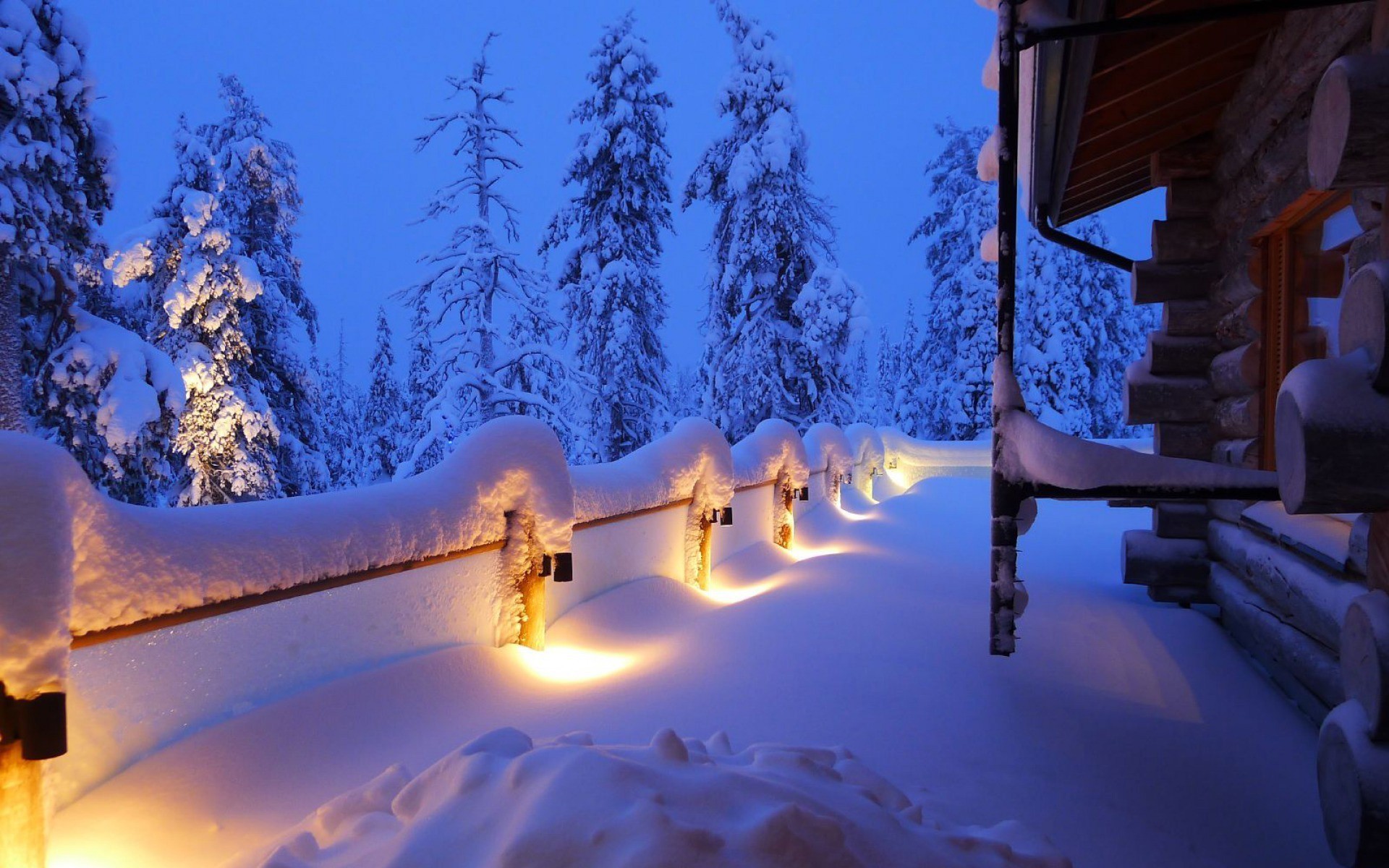 Snowy log cabin with lights and trees HD Wallpaper