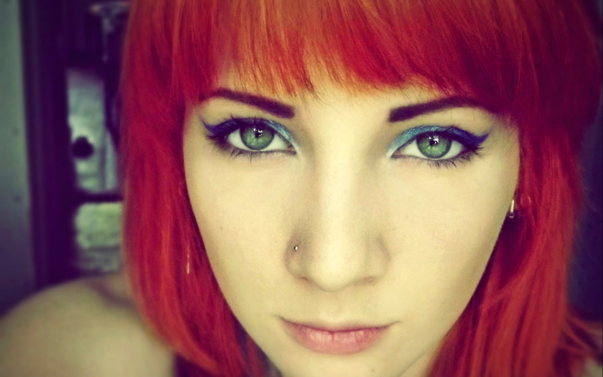Close-up of a young woman with red hair and blue eyeliner HD Wallpaper