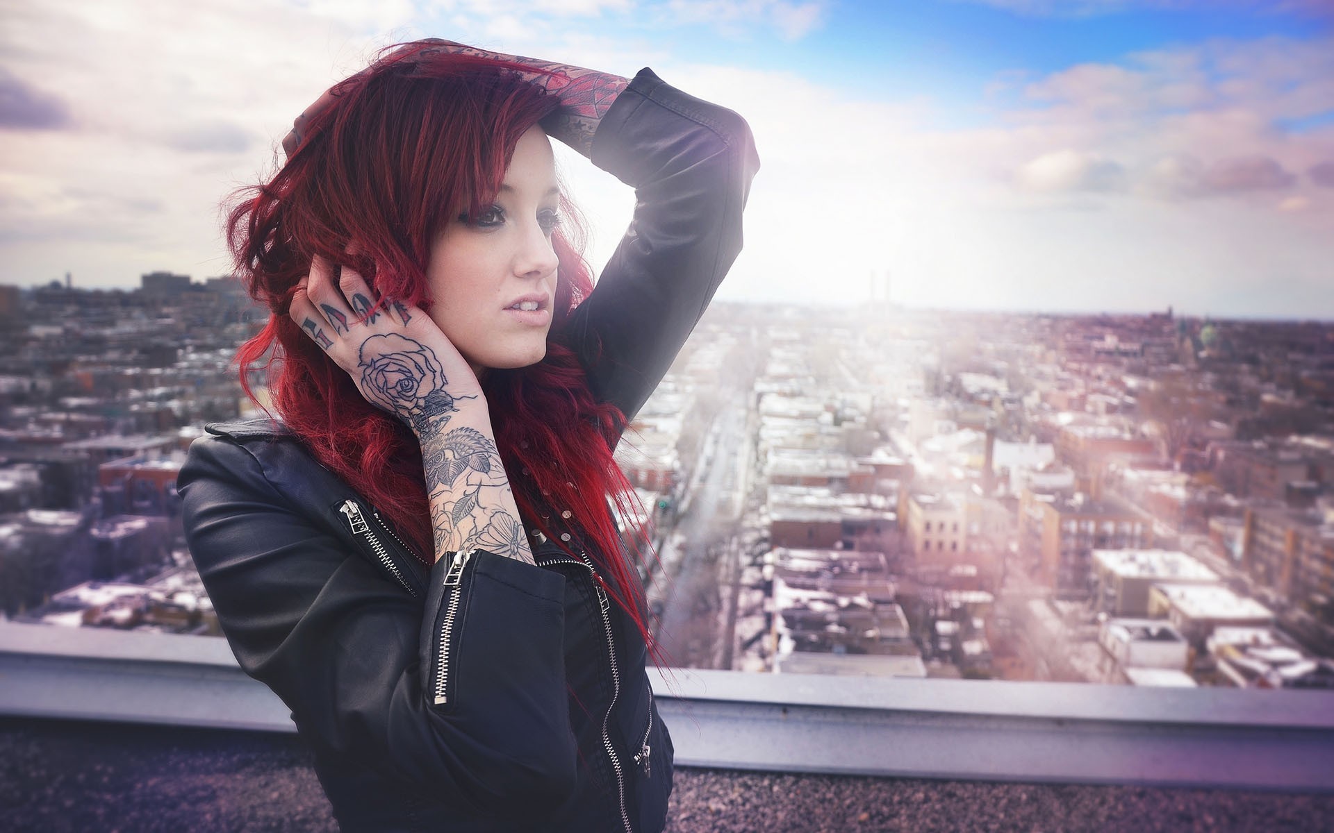 Woman with red hair and tattoos on a rooftop overlooking city HD Wallpaper