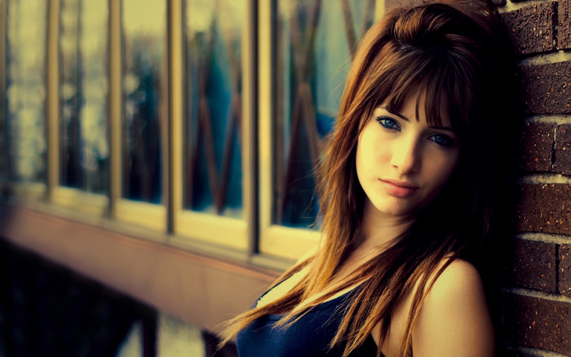 Susan Coffey leaning against a brick wall HD Wallpaper