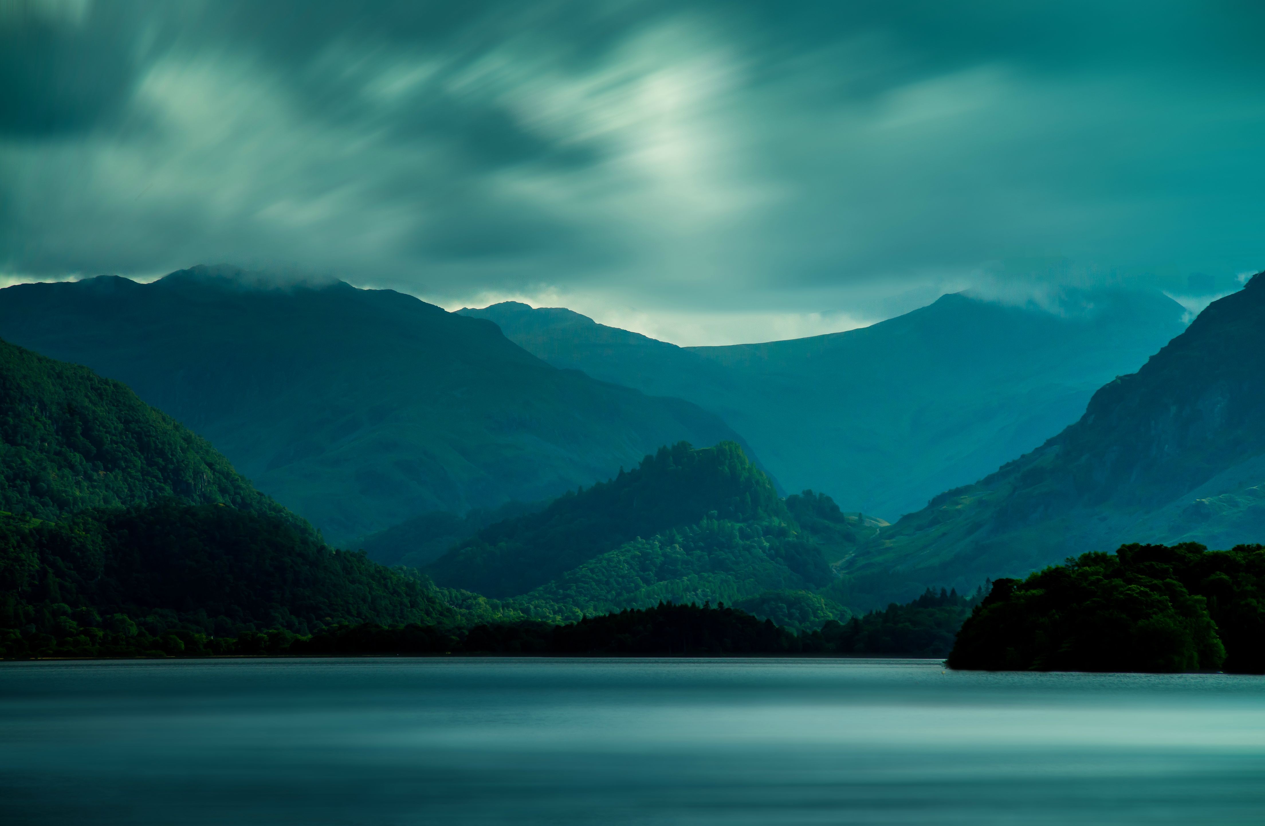 Misty mountains over a calm lake HD Wallpaper
