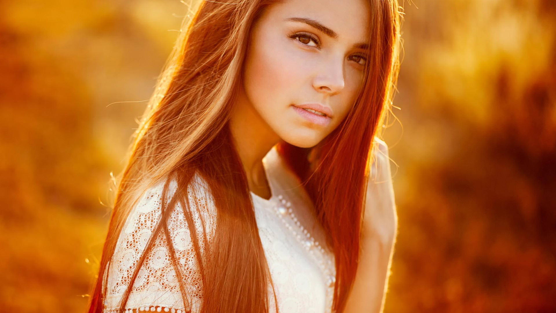 Woman with long straight auburn hair in golden hour light HD Wallpaper