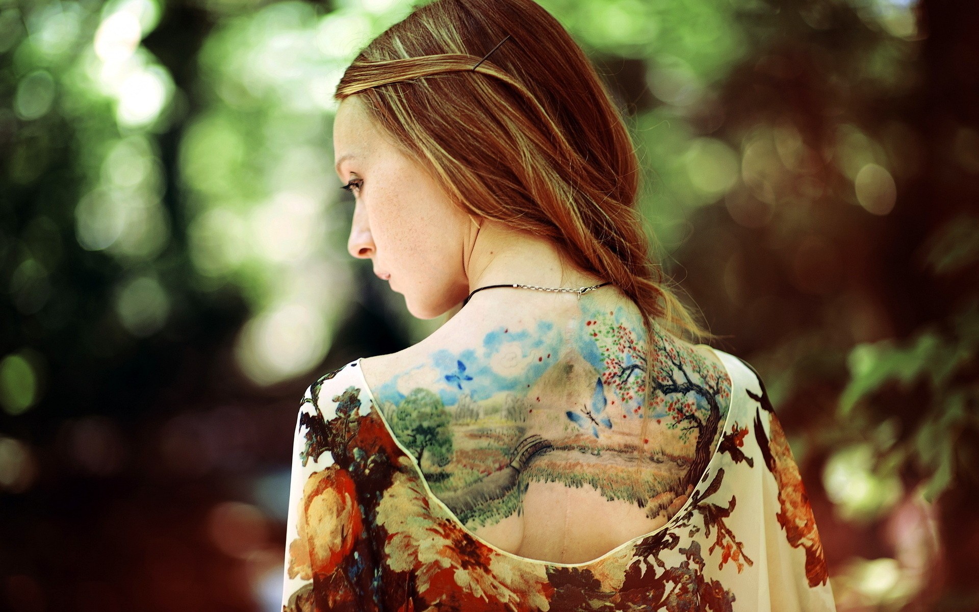 Woman with a landscape tattoo on her back HD Wallpaper