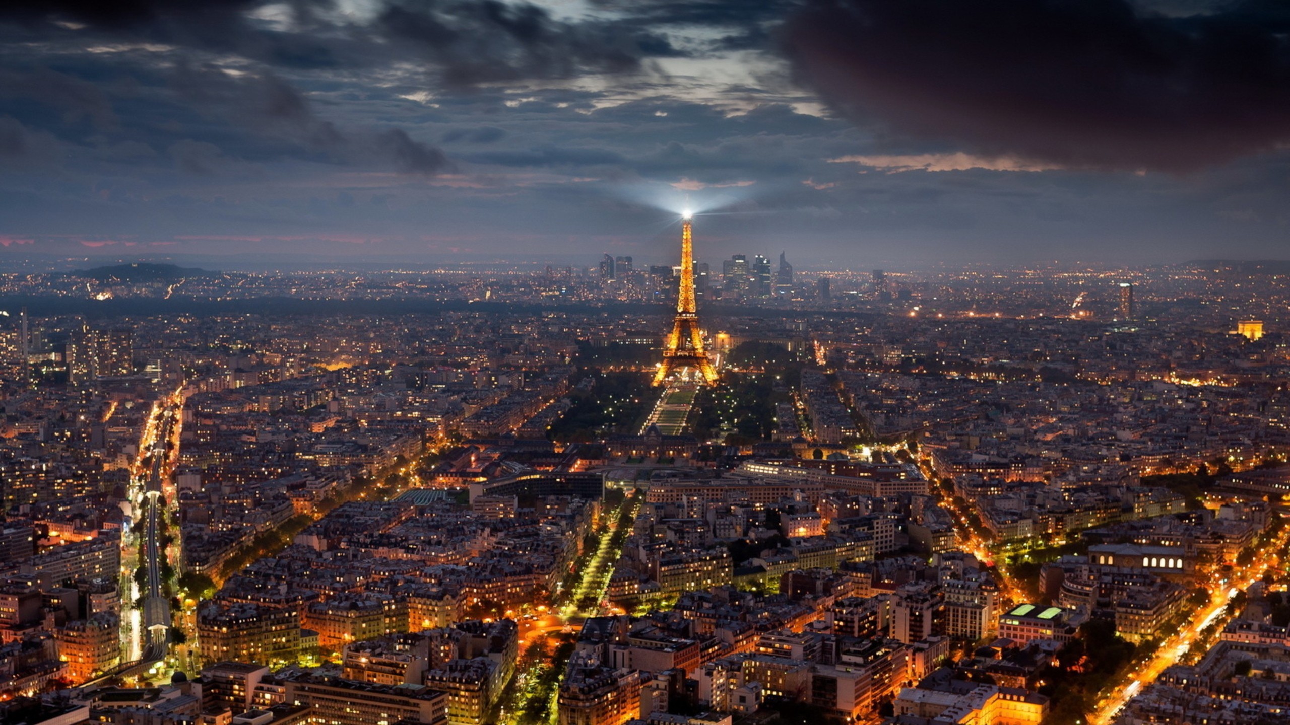 Eiffel Tower illuminated at night over Paris cityscape HD Wallpaper
