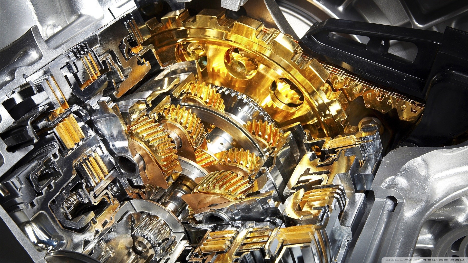 Cutaway view of a gold and silver automatic transmission gearbox HD Wallpaper