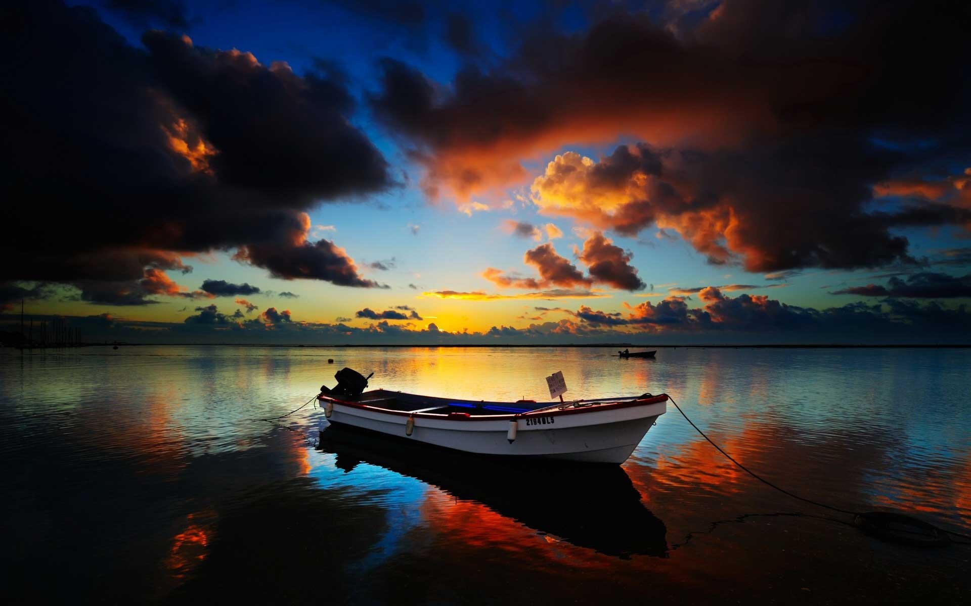 Boat on the water at sunset with colorful clouds HD Wallpaper