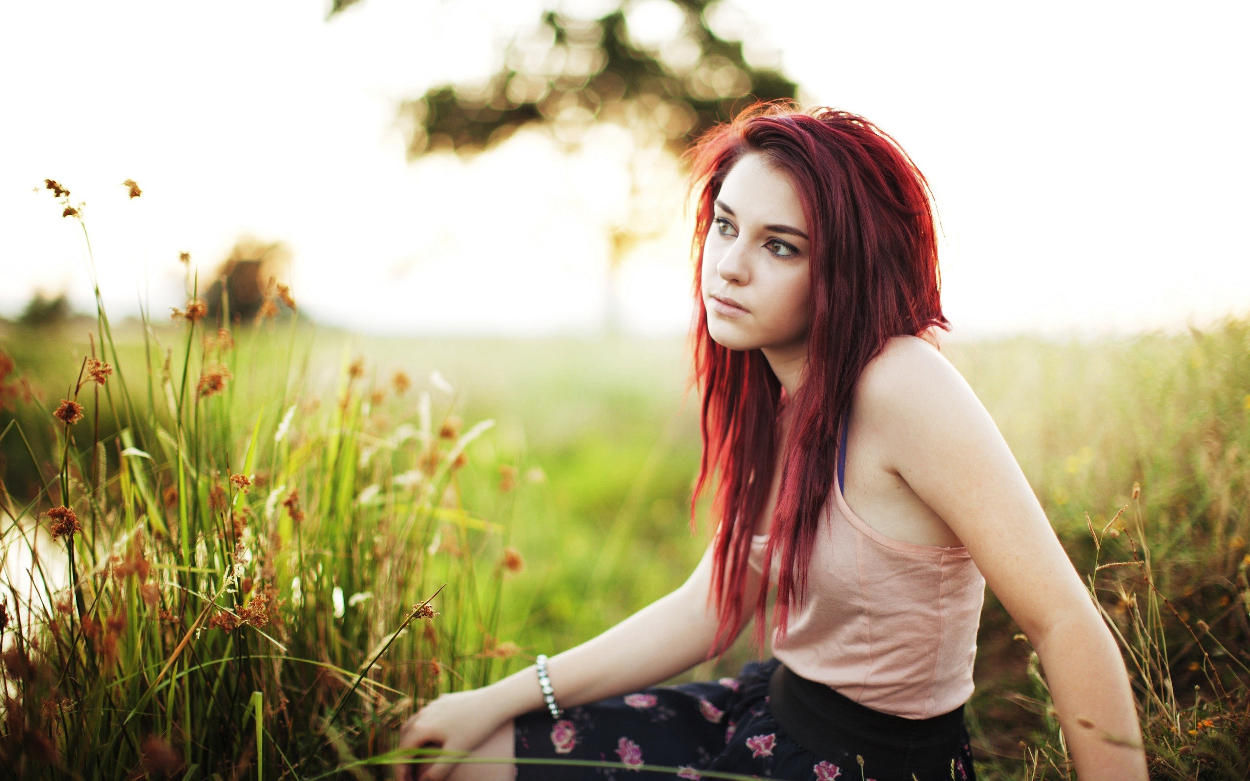 Tosha McCarter sitting in a field of grass HD Wallpaper