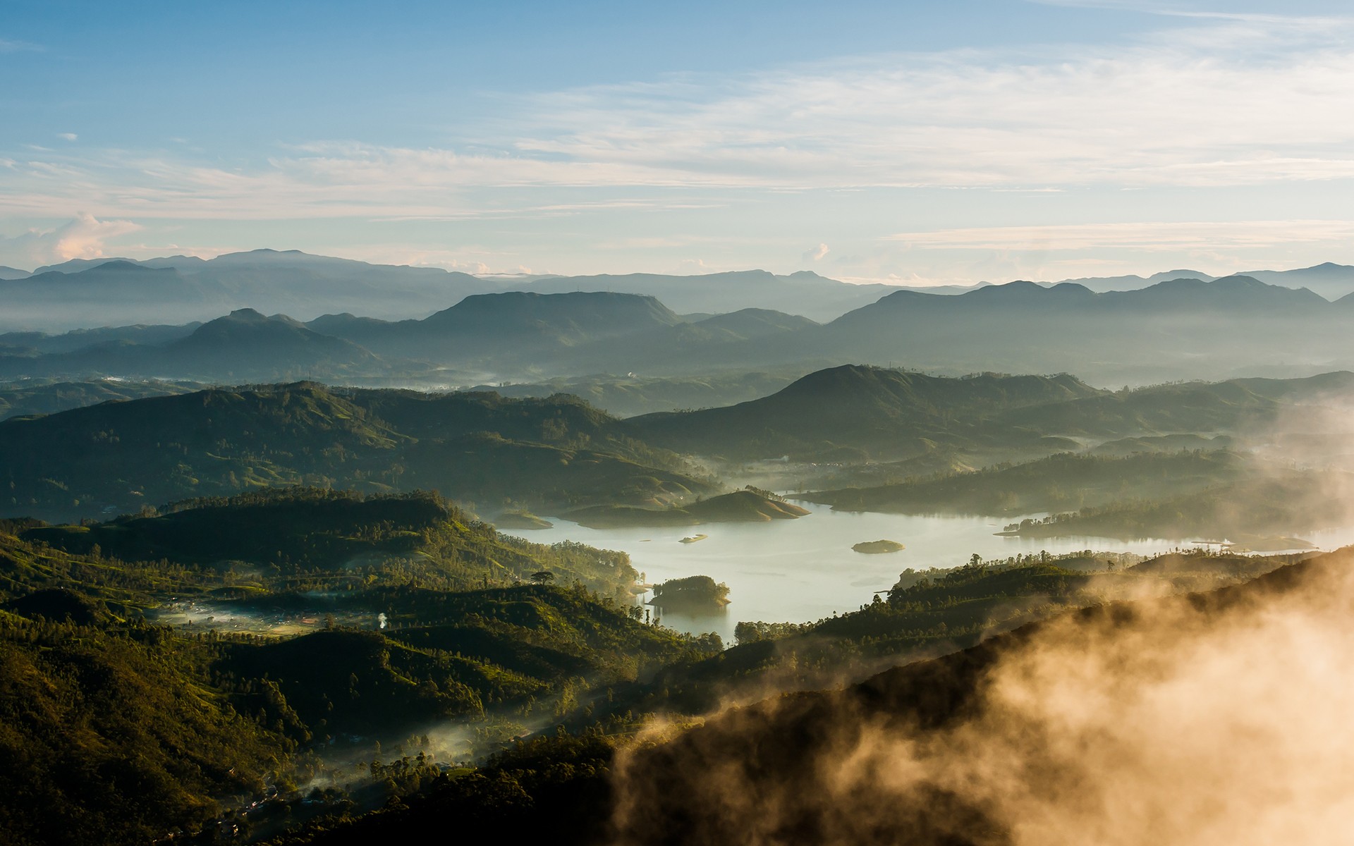 Misty mountains and a lake at sunrise HD Wallpaper