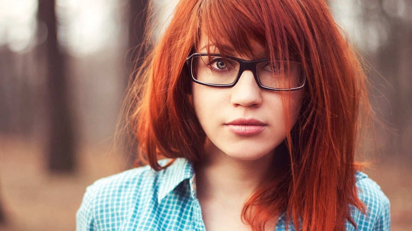 Woman with red hair and glasses in a forest HD Wallpaper