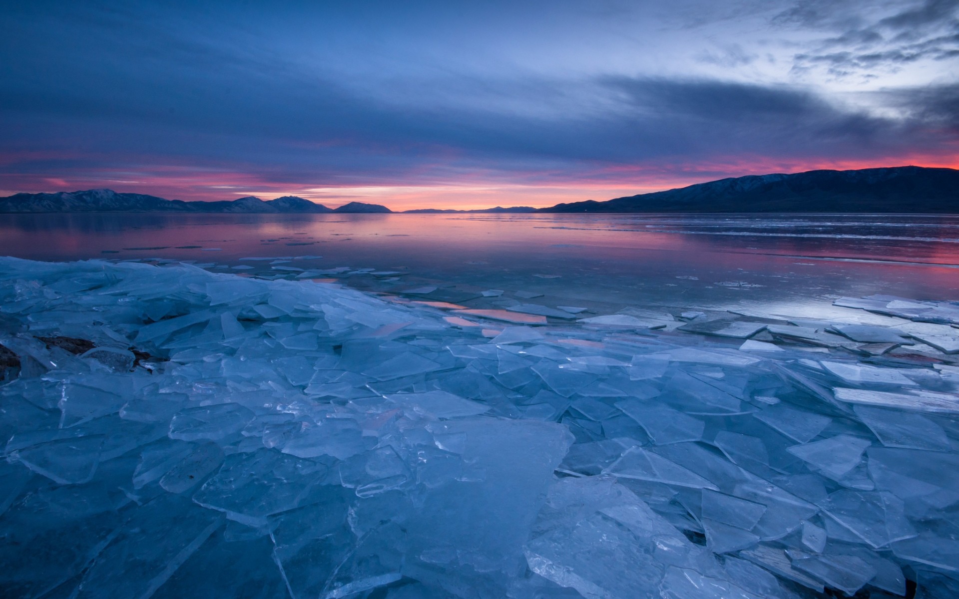 Ice shards on a frozen lake at sunset HD Wallpaper