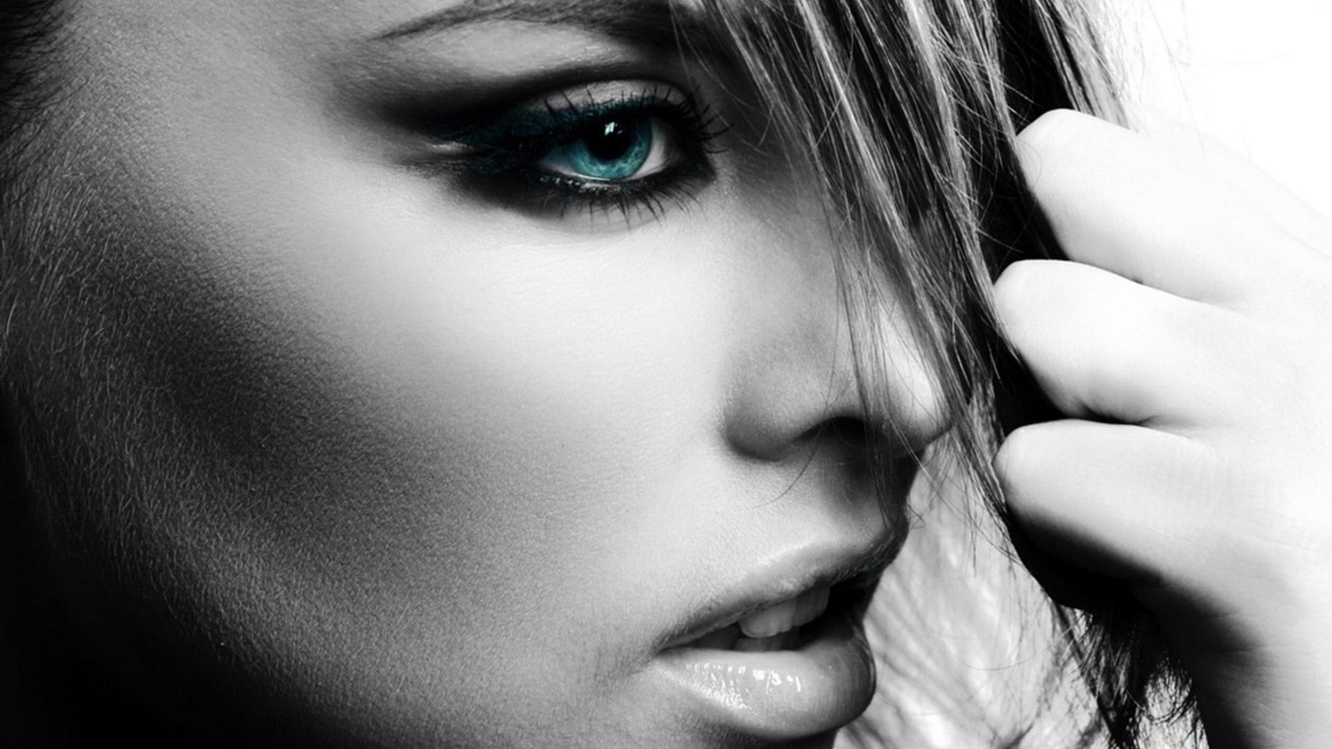 Woman with striking blue eye and hand in hair HD Wallpaper