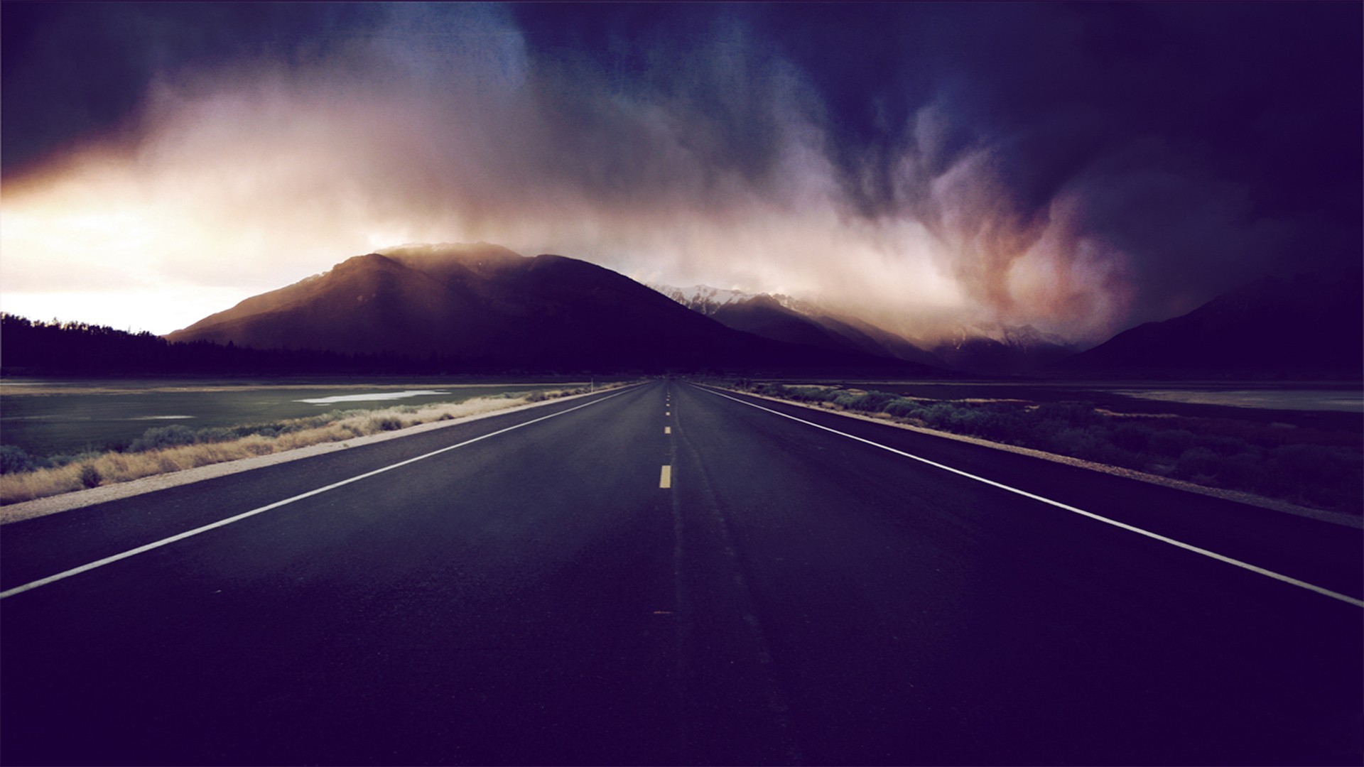 Road leading to mountains under stormy sky HD Wallpaper