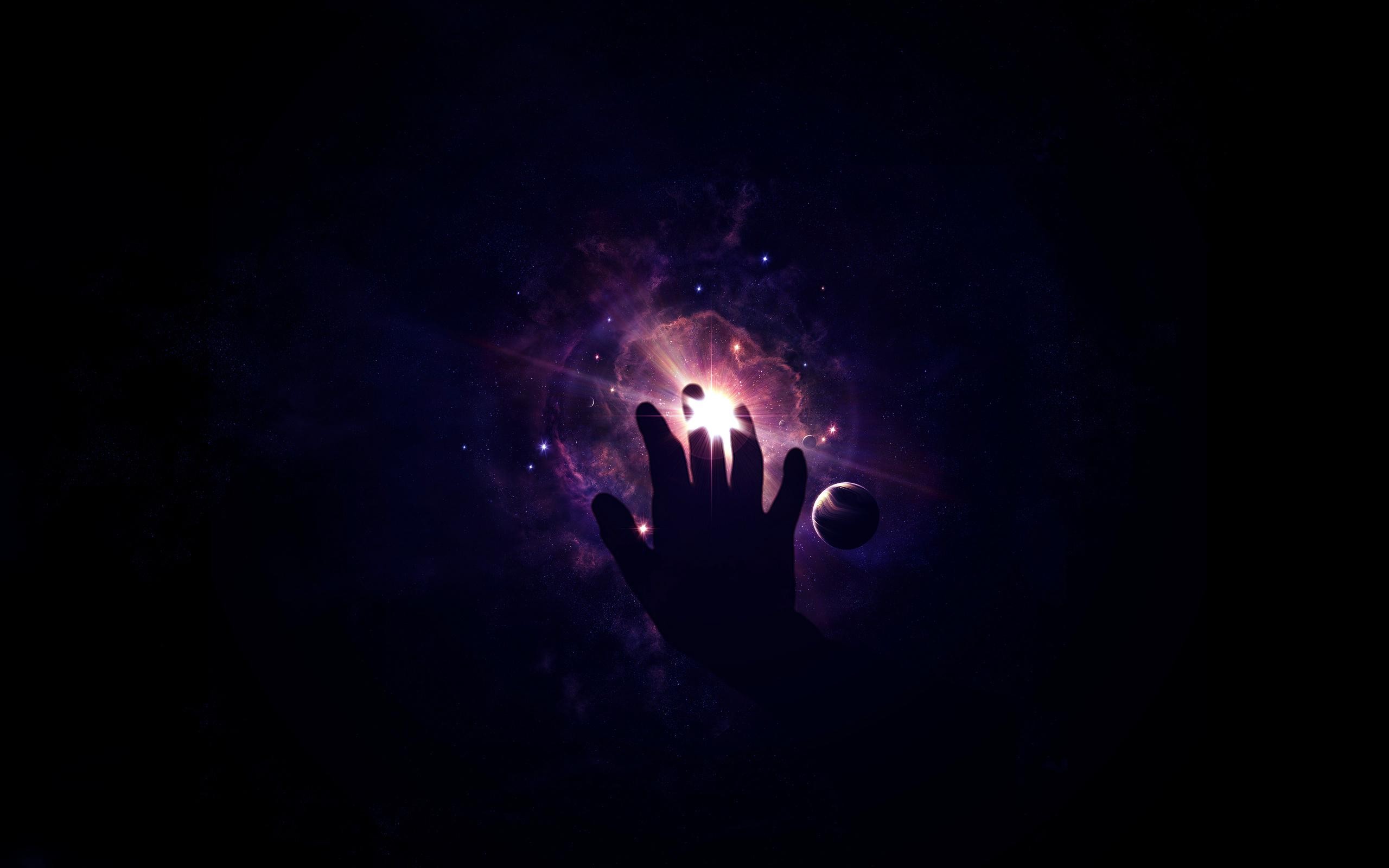 Hand reaching towards a bright nebula in space HD Wallpaper