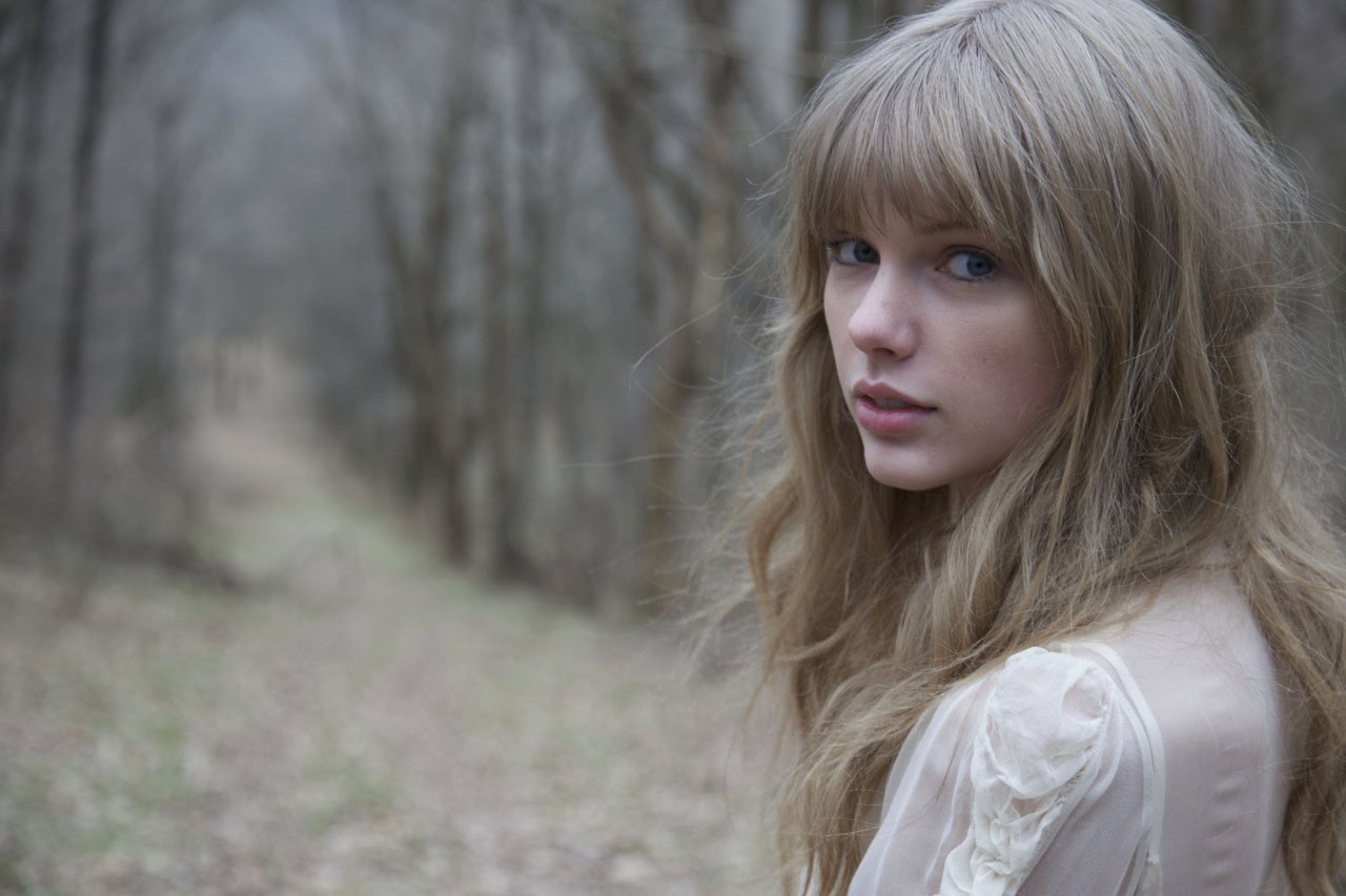 Taylor Swift in a forest setting HD Wallpaper