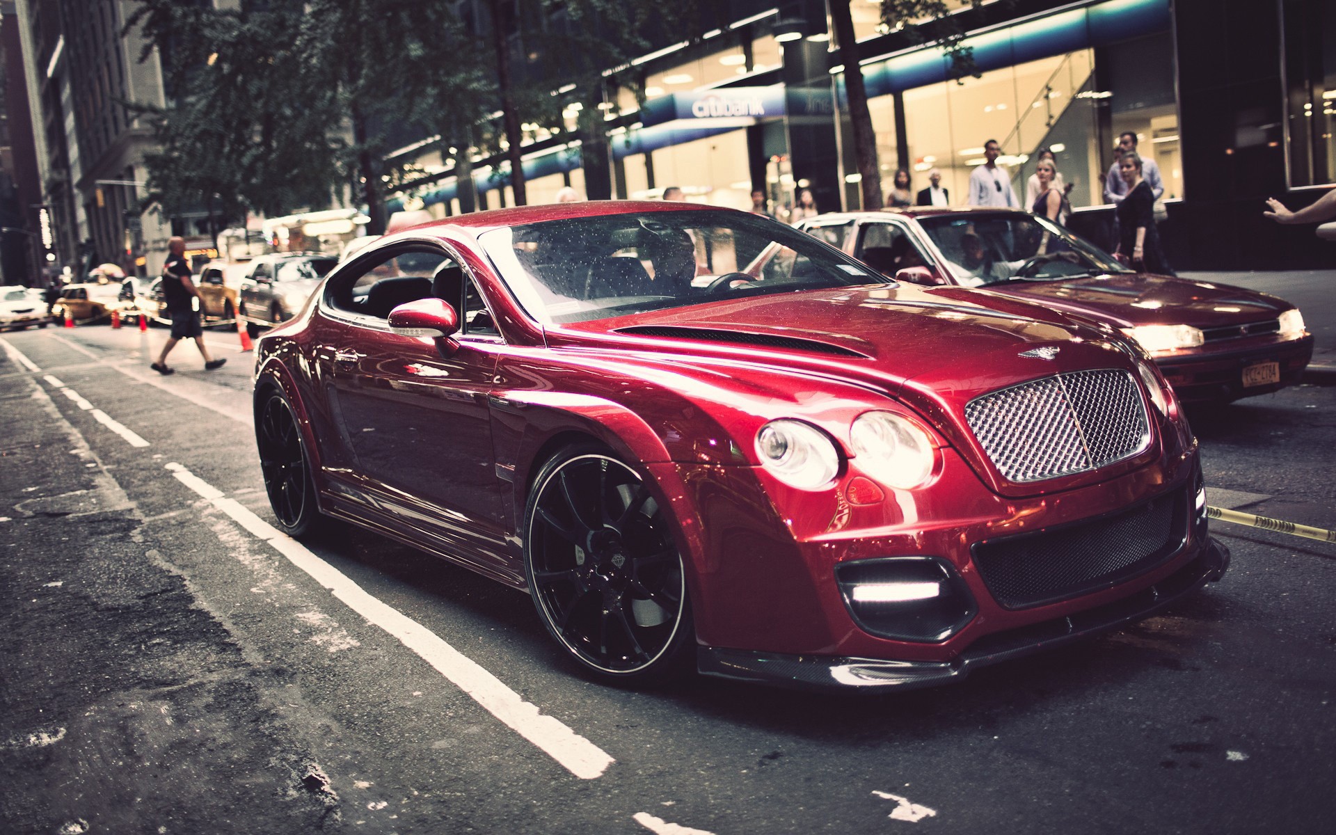 Red Bentley Continental GT parked on a city street HD Wallpaper