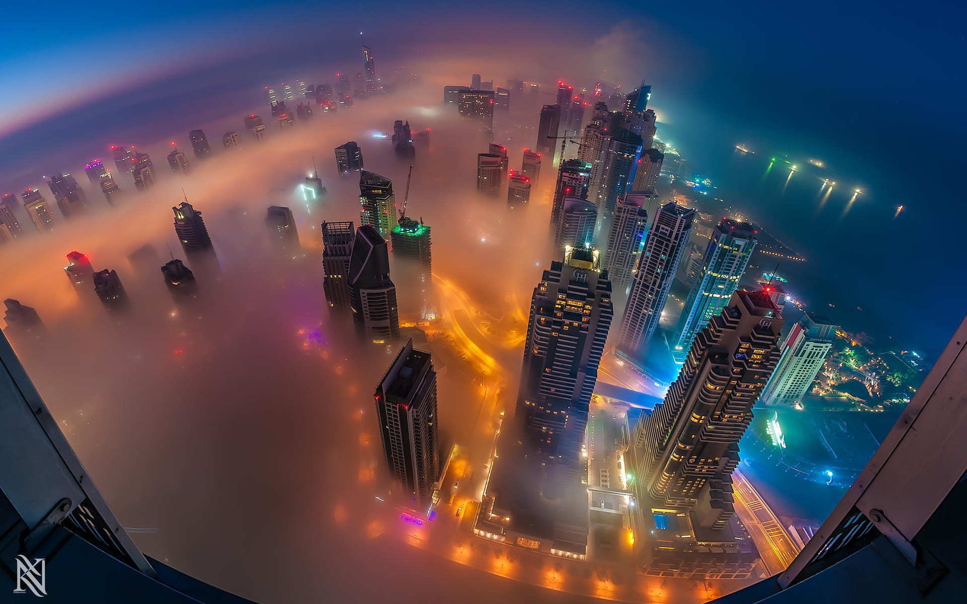 Dubai cityscape shrouded in fog at night HD Wallpaper