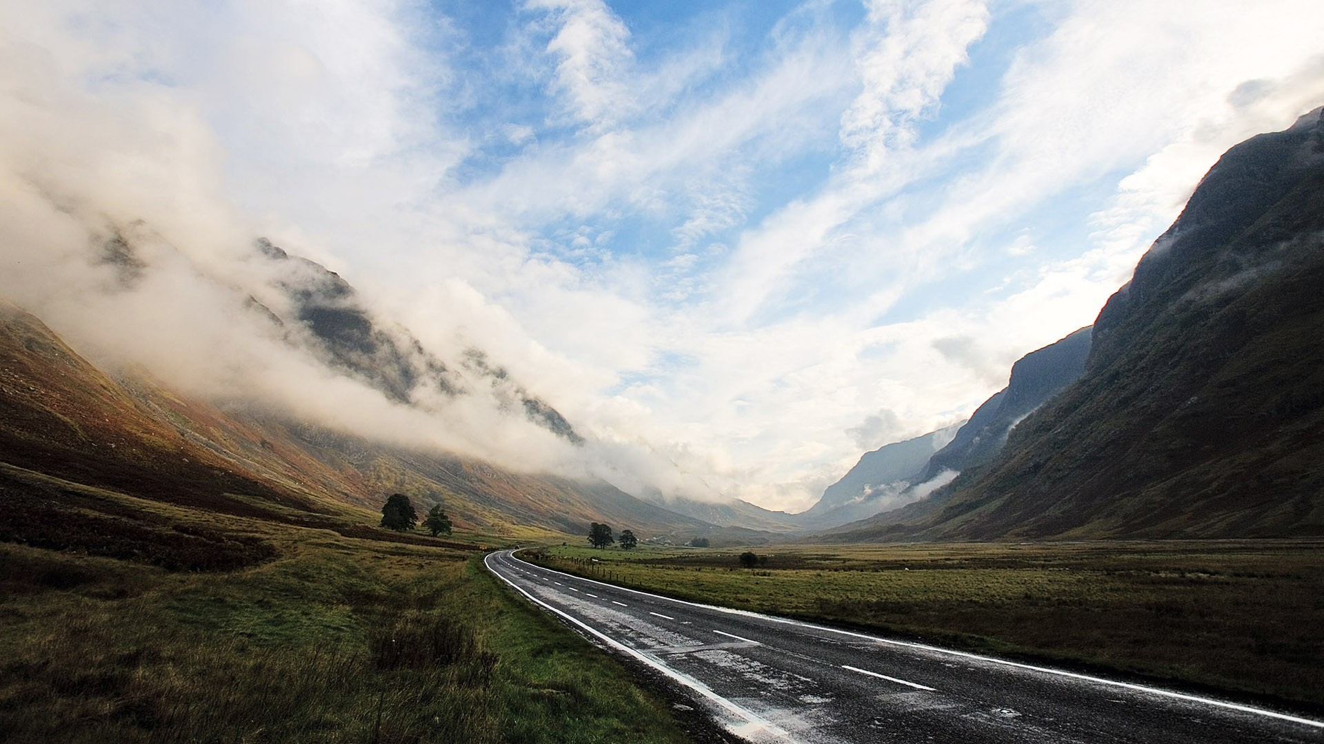 Road through a misty mountain valley landscape HD Wallpaper