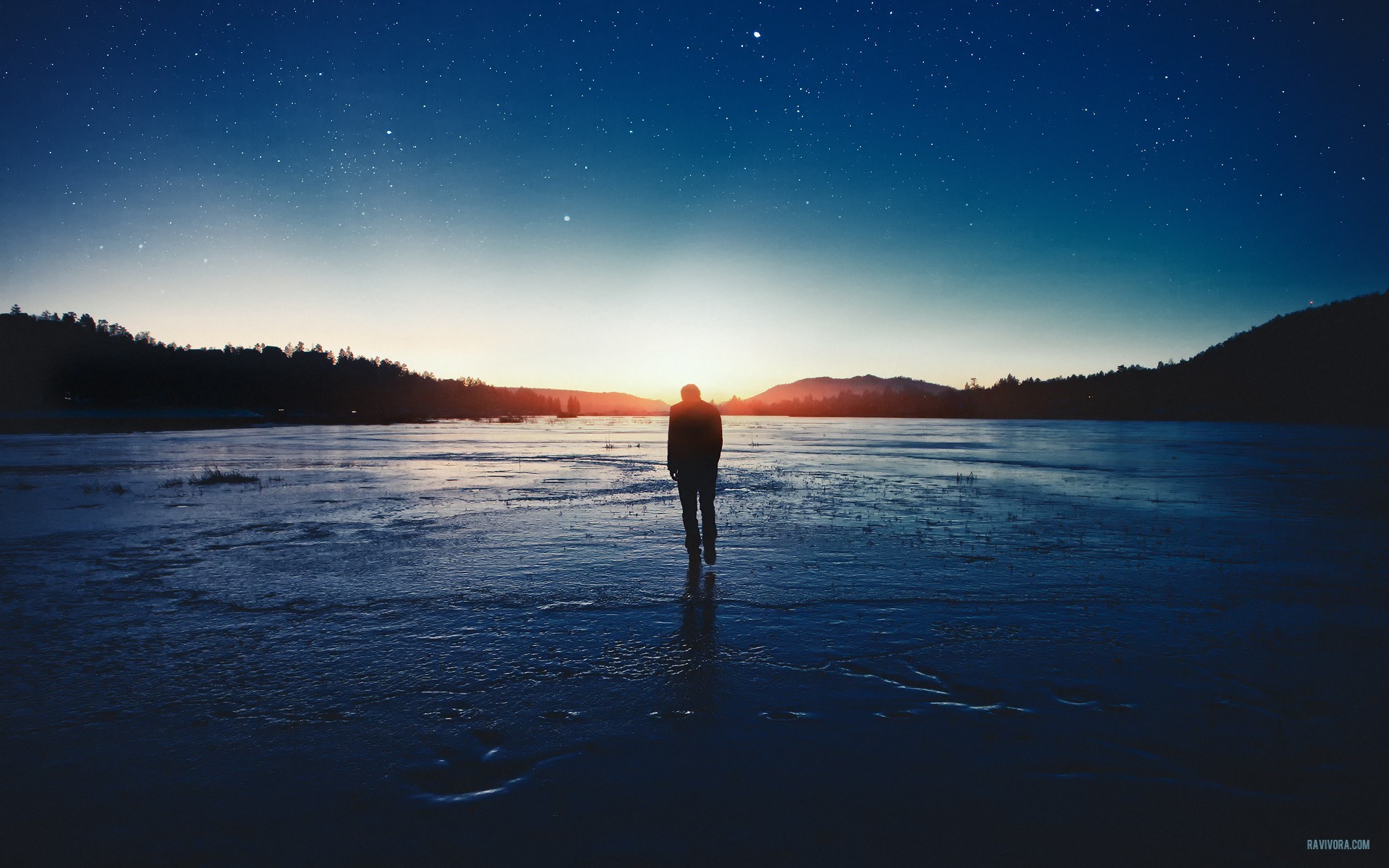 Man walking on ice under starry sky at sunset HD Wallpaper