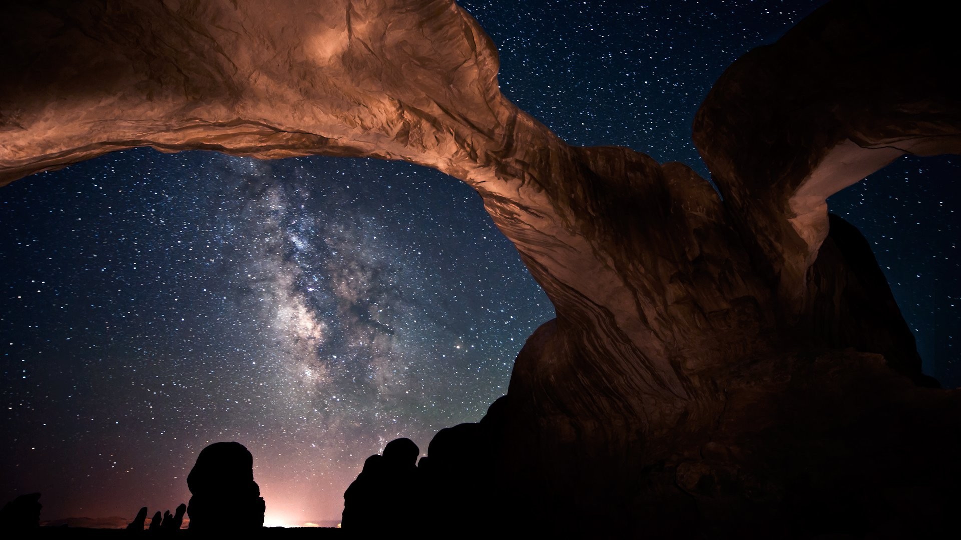 Milky Way galaxy seen through rock arches at night HD Wallpaper
