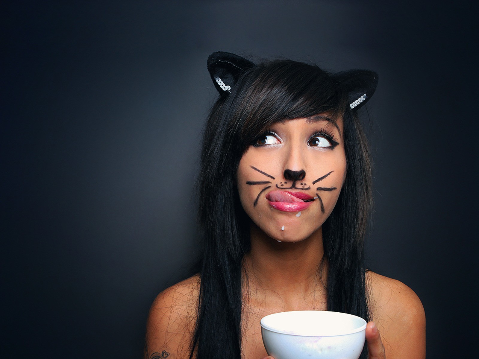 Woman with cat makeup and ears holding a bowl HD Wallpaper