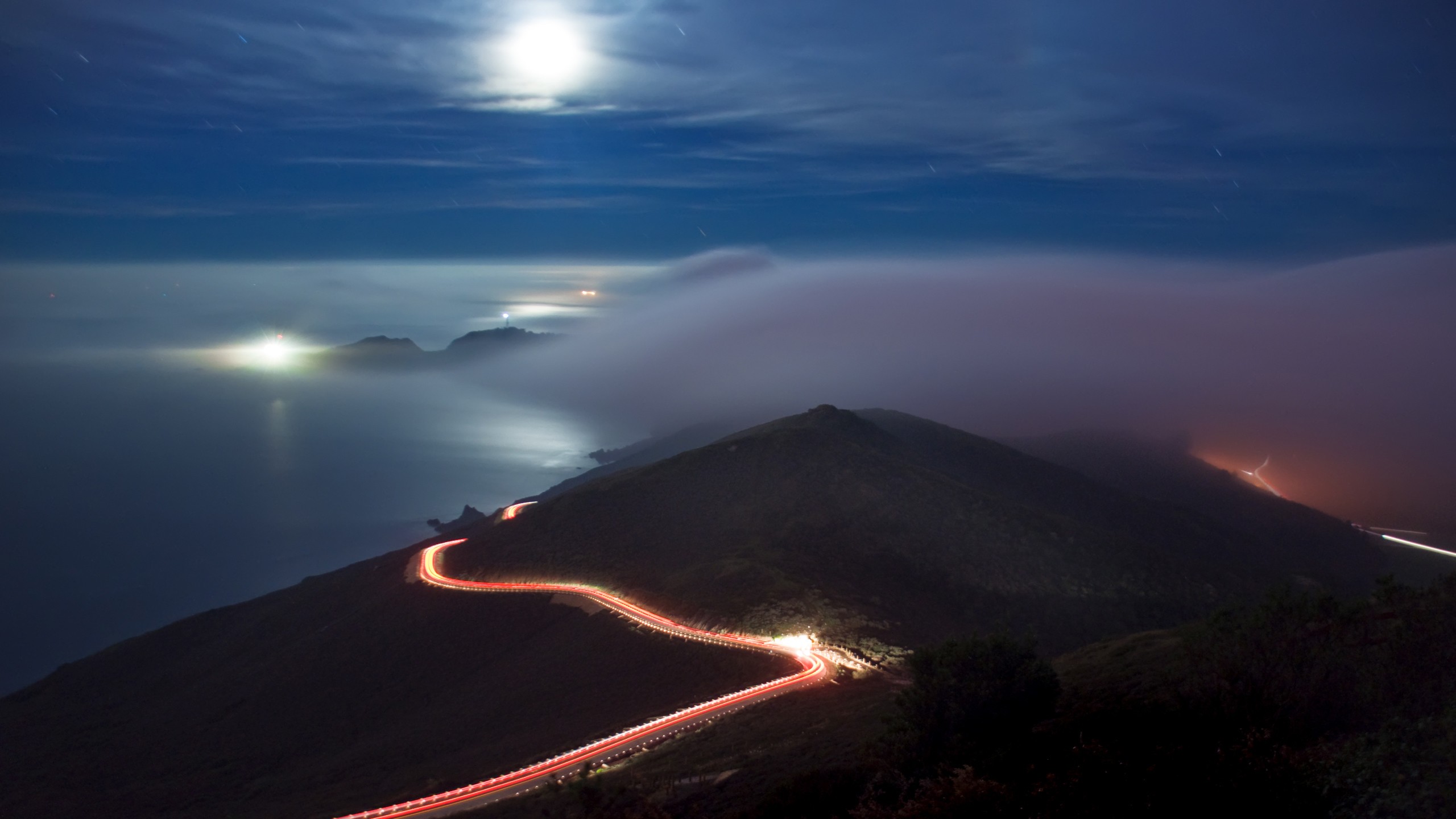Night road with light trails along the coast under the moon HD Wallpaper