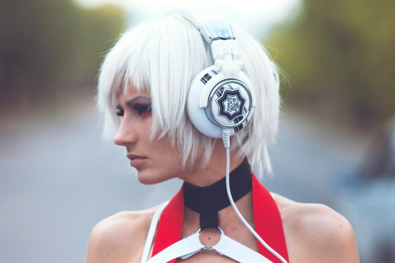 Woman with white hair wearing headphones and red outfit HD Wallpaper